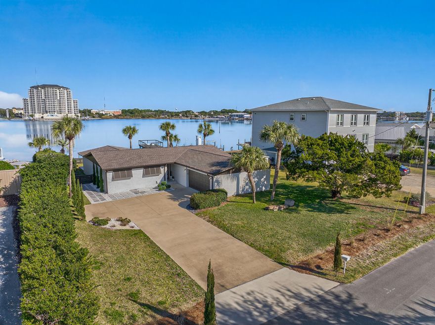 Stunning newly renovated waterfront home on Okaloosa Island offering 85 feet of deep-water frontage on the Santa Rosa Sound. Enjoy breathtaking sunsets and effortless boating with direct access to the Gulf of America. This fully furnished 3-bedroom, 2-bath residence features an oversized primary suite, brand-new LVP flooring throughout, and a durable 2024 roof for added peace of mind. The beautifully updated kitchen and bathrooms are finished with elegant quartz countertops, blending style and functionality. Hurricane-proof sliding glass doors frame the water views while enhancing safety and energy efficiency. A two-car garage provides ample storage for vehicles and coastal gear. Move-in ready and perfectly positioned for relaxed waterfront living or entertaining, this home delivers the  best of modern comfort and island lifestyle.