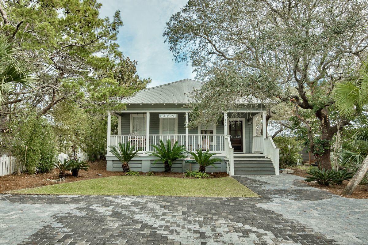 Charm abounds in this 1950s bungalow on a huge lot & a half in Grayton Beach, just a block & a half from the beach access! New, wood privacy fence has a huge gate to the rear alley allowing for boat & RV parking!Large pool for relaxing under the oaks! Flickering gas lanterns frame the front entrance. Living areas are open & light-filled characterized by original wood floors, painted bead board ceilings & charming coastal decor. An up-to-date kitchen designed by Matt Savoie appears perfectly period with its checkerboard floor & stainless steel backsplash, tying in matching appliances and