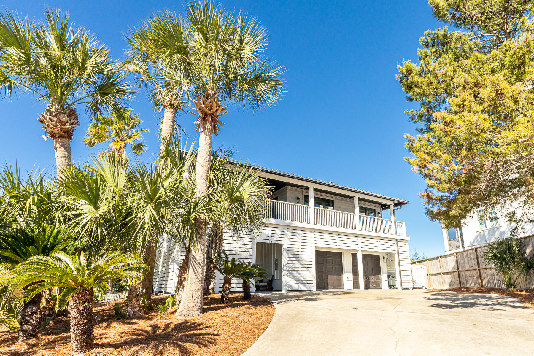 Situated on a rare 1/2 acre lot at one of the highest elevation points on 30A, this Blue Mt Beach home with a private pool, gulf views, fully furnished and no HOA is an investor's dream (projections of $280,000). Featuring 6 bedrooms plus 2 bunk rooms, 5 full baths, 2 kitchens, 2 sets of Washer/Dryers and several gathering areas, this sprawling layout can easily accommodate parties of 25 or more while maintaining a sense of privacy.   An extensive ''down to the studs'' remodel includes a new metal roof, windows, doors, siding, upgraded plumbing, electrical, kitchen, bathrooms, decking, LVP flooring and more.  Upstairs, the living area and dining room meet with a wet bar which wraps around to a peninsula gas fireplace.