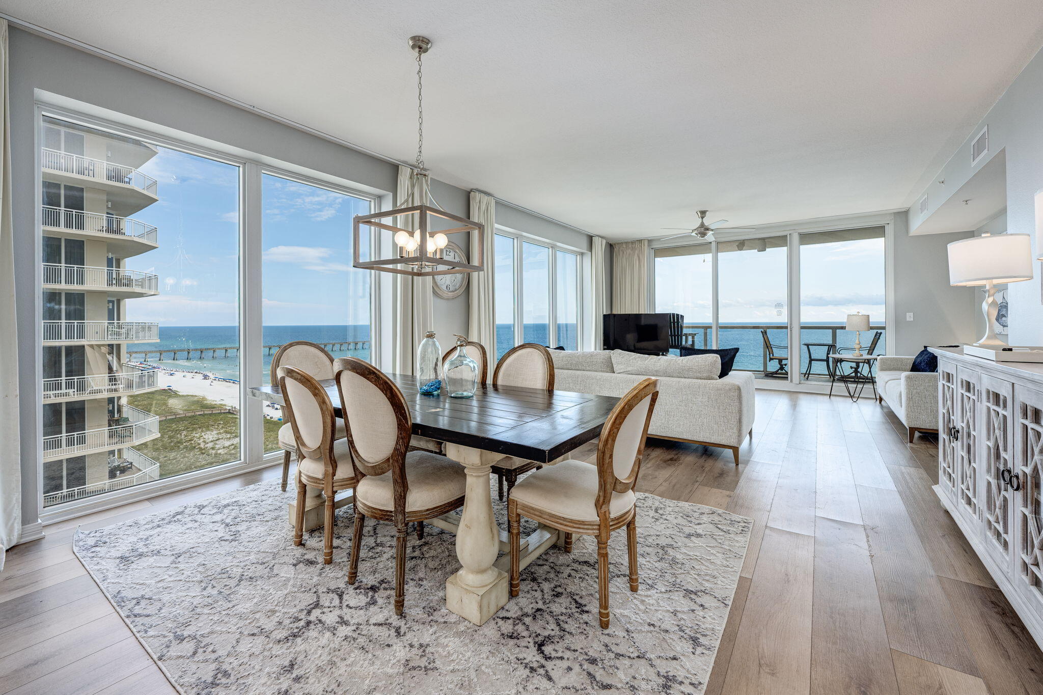 This stunning 10th-floor, east-end corner unit at Caribbean Resort offers breathtaking views and is a high-performing rental property, generating an impressive $100K in revenue in its first 12 months! A true standout in the rental market, this unit underwent a top-to-bottom renovation in Fall/Winter '23/'24. (See Notable Features sheet in MLS Docs.) It is being sold FULLY FURNISHED, making it a turnkey investment or dream vacation home. Spanning over 1,800 square feet, this expansive unit boasts a thoughtfully designed floor plan. The floor-to-ceiling, 9-foot windows and sliding glass doors showcase panoramic, picture-perfect views of the Gulf and the iconic Navarre Beach Pier. These spectacular windows are featured throughout the living and dining area, as well as in the master bedroom  and unique lock-out bedroom, ensuring that nearly every room is bathed in natural sunlight with captivating scenery. The unit features a lock-out bedroom, which includes its own private entrance, kitchenette, en-suite bathroom, hot water heater, and HVAC system. Step out onto the private balcony to take in the mesmerizing Gulf-front and sunset views, some of the very best that Navarre Beach has to offer. The modern, fully renovated kitchen is both stylish and functional, featuring sleek stainless steel appliances, contemporary white cabinetry, and an eye-catching backsplash. From its prime beachfront location to its exceptional design and rental potential, this unit is a rare find. Experience the best of Navarre Beach with luxury, comfort, and unbeatable Gulf views all in one place!