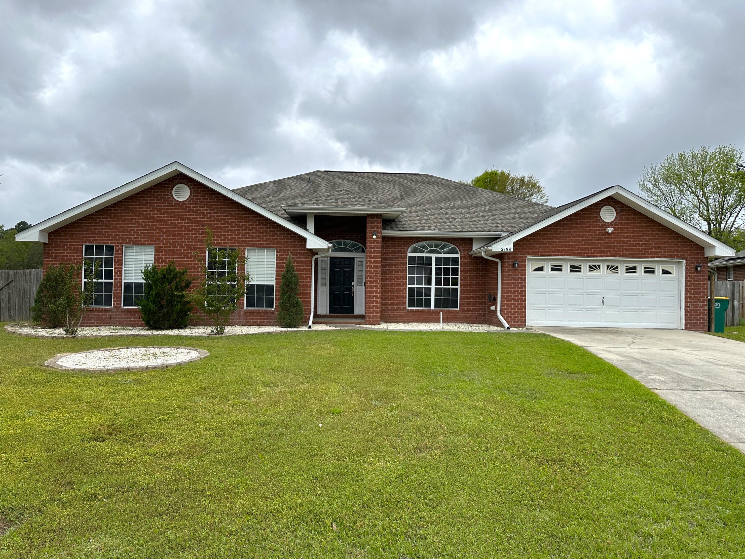This open concept 4 bedroom, 3 bath, all brick home sits on a 0.49-acre flat lot. This home is almost 3000 SqFt and feels every bit of it with the open living, dining and kitchen areas. It boasts high ceilings and has pillars through the central living area. The kitchen has updated backsplash and lighting, barstool seating, beyond ample storage space with cabinets all around the kitchen. The kitchen leads into the large walk-in pantry which contains wall to wall storage space. Beyond the pantry is the designated laundry room, which also has a door leading to the back patio. Back through the kitchen you walk out to the built-in book shelfs, and workspace and a gun safe that stays. Desk, open concert workspace. The primary bedroom has two entries into the bathroom,