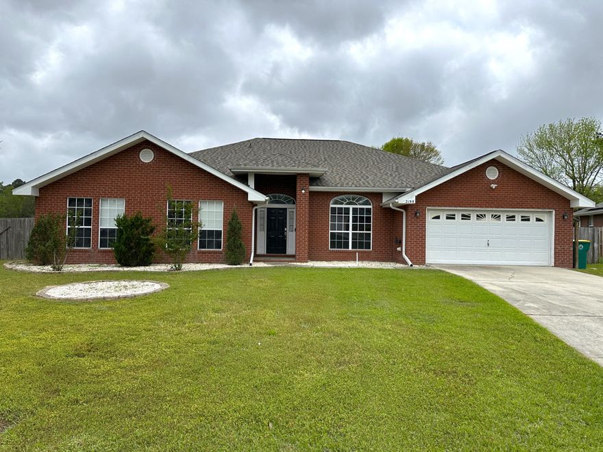 This open concept 4 bedroom, 3 bath, all brick home sits on a 0.49-acre flat lot. This home is almost 3000 SqFt and feels every bit of it with the open living, dining and kitchen areas. It boasts high ceilings and has pillars through the central living area. The kitchen has updated backsplash and lighting, barstool seating, beyond ample storage space with cabinets all around the kitchen. The kitchen leads into the large walk-in pantry which contains wall to wall storage space. Beyond the pantry is the designated laundry room, which also has a door leading to the back patio. Back through the kitchen you walk out to the built-in book shelfs, and workspace and a gun safe that stays. Desk, open concert workspace. The primary bedroom has two entries into the bathroom,