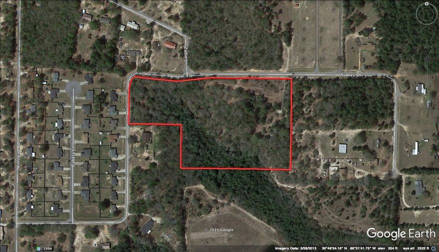 Homesite Dream! Huge hardwoods small creek and lots of Paved road frontage! This location is in the Auburn area near the new developing commercial of North Crestview! With highway 85 near by its just a quick commute to Crestview, Eglin and Destin Beaches! Bring you barn, RV and your house-plans today! Sale contingent on satisfactory lot split. Additional acreage available!!