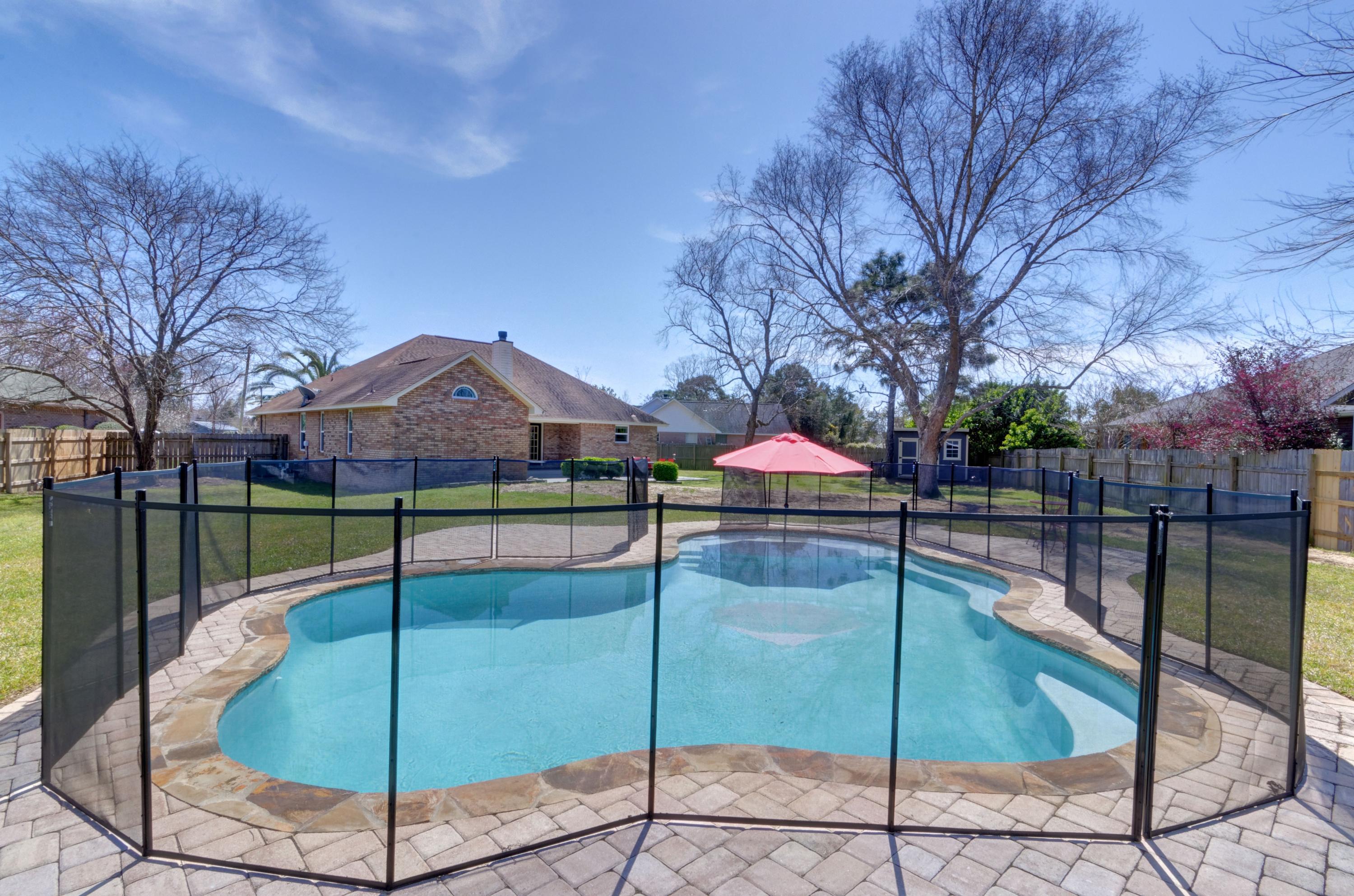 *POOL HOME* This is the one you've been waiting for! Welcome home to this stunning all brick and renovated east Navarre home located on an sprawling lot nestled on a cul-de-sac. Featuring a long list of fantastic seller updates, this three bedroom, 2 bath home is the perfect retreat to enjoy the best of Florida living in your own backyard inground gunite pool - complete with a tanning ledge and seating and a child safety fence for peace of mind! Pull up in the cul-de-sac and enjoy the oversized parking with the extended driveway, and the new hurricane rated garage door. Walk inside and appreciate the 10ft ceilings and open floor plan with a beautiful brick wood burning fireplace focal point. Directly to the left enjoy a bonus space (currently used as a playspace and reading nook!).