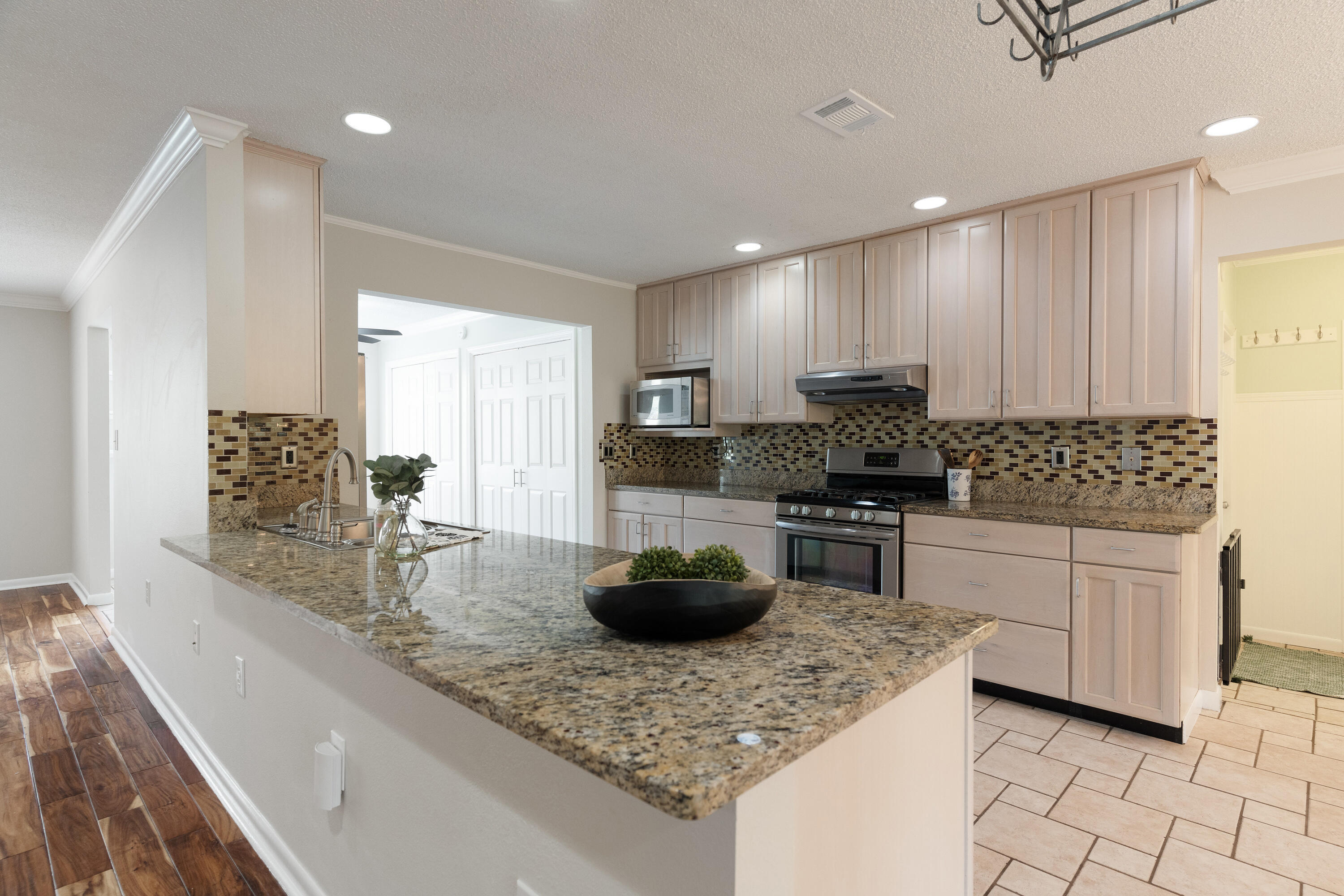 Don't miss this charming home in the highly sought-after Lake Lorraine Estates! Ideally located near Eglin AFB, schools, the post office, baseball fields, and more, this beautiful property sits in a well-established and welcoming neighborhood.Inside, you'll find a spacious yet inviting layout filled with natural light. The family room features a stunning brick-framed fireplace--perfect for cozy evenings. The large kitchen offers gorgeous granite countertops, bleached wood cabinetry, and a stylish glass tile backsplash, making it both functional and beautiful.The master suite includes a generous walk-in closet and a private bathroom with a fully tiled walk-in shower. Two additional bedrooms share a stylish full bath complete with a classic clawfoot tub and modern finishes. A versatile bonus room located just off the garage entry can serve as a home office, fitness room, or hobby space. Additional features include washer/dryer hookups, ceiling fans in every bedroom, and a spacious backyard ideal for summer barbecues and outdoor fun. Along with a single car garage outdoor storage! Truly a gem!