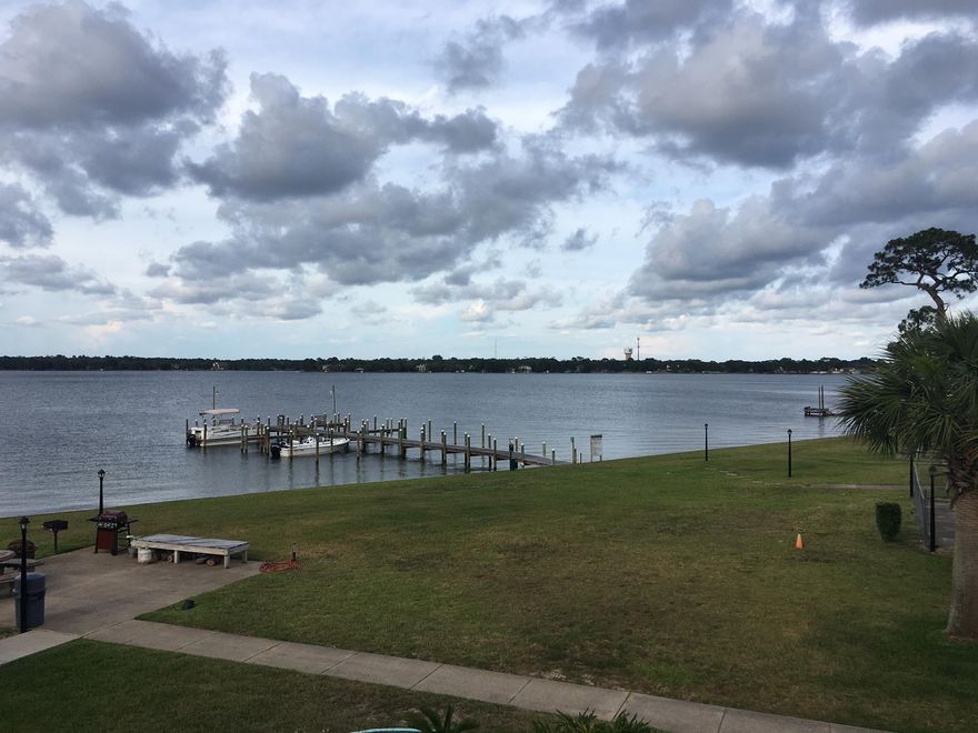 Want a great investment property? Or maybe you want to drink your coffee in the morning and your cocktail in the evening while savoring your own beautiful bayou view? Here is your opportunity! A gorgeous Garnier Bayou location, large grassy lawn, community pool, dock, 2 barbecue/picnic areas and laundry facility. This upstairs 2 bed/1 bath unit in one of the more private buildings of the community has a panoramic view of it all! Close to Eglin, FWB Med Center and Hurlburt, this centrally located community is close to schools, shopping, golf courses, you name it. Boat slips available. UPDATED kitchen, bath. Inside AC unit replaced 2014; outside unit 2010. Reserved parking space + guest parking. Buyer to verify all information.