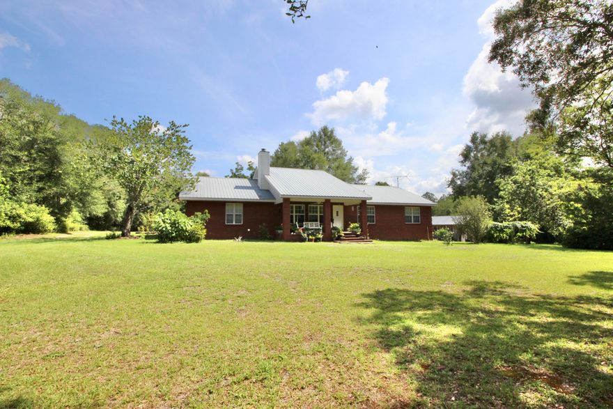 Remarkable homesite of 15 acres with custom brick home, just 10 minutes to downtown historic DeFuniak Springs. Huge oaks, green fields, and established country setting and you know this one has that special, ''it factor''. U-shaped kitchen has amazing amount of custom wood cabinets and solid surface countertops. Double pantry and 20x11 utility room! Wood burning brick fireplace can heat the whole home per seller. Dining room at 15x18 has plenty of room for a full dining set! But the sunroom is where you'll want to spend most of your time...peace & tranquility follow, as you sip coffee and relax. Pear, persimmon, mulberry & pecan trees, along with scuppernongs and blueberries, and it is a veritable slice of (yummy) heaven. Brand spanking new HVAC