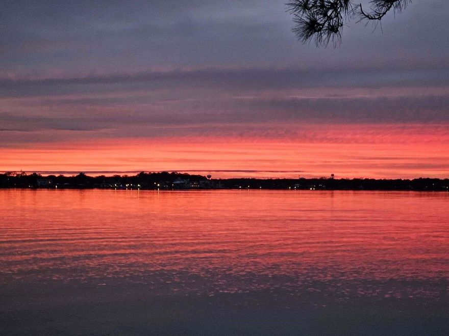 Newly renovated with Plex plumbing and interior painting and removal of wallpaper.  Seller is accepting Backup Offers. Discover the epitome of Florida living in this exceptional residence. The expansive living room boasts a gas fireplace and offers panoramic views of the bayou, providing a backdrop to the most captivating sunsets. The kitchen is adorned with modern stainless-steel appliances and features a breakfast bar seamlessly integrated with the living area, facilitating effortless entertaining.Equipped with the convenience of a whole-house generator compatible with both gasoline and LP gas, along with hurricane shutters for storm protection.  The seller is also offering a home warranty for the buyers peace of mind. The bathrooms on the upper level have been tastefully renovated,