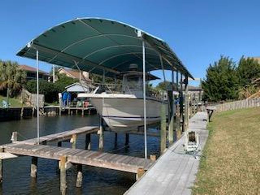 Don't let this DEAL get away! Beautiful waterfront home in Santa Rosa Shores! Nice open floor plan w/ a great view of the canal. Oversized bedrooms. Updates in kitchen include granite & new appliances in 2017. Center room wood burning brick fireplace w/ new mortar inside/out. Water heater replaced in 2018, Heat/Air unit replaced in 2016. All windows except ones in A Frame were replaced w/ high impact windows in 2010. Screen back porch enclosed in 2013. Lot is 80' wide on canal w/ deep water. 13K lb. boat lift w/ a $7500 vinyl boat cover added. Roof w/ 30-year comp shingles replaced in 2005. Hot Tub on back porch, washer/dryer, refrigerator & freezer in garage will convey. No flooding occurred during Hurricane Ivan. Owners have been there since 1994. Detailed photos & virtual tour coming