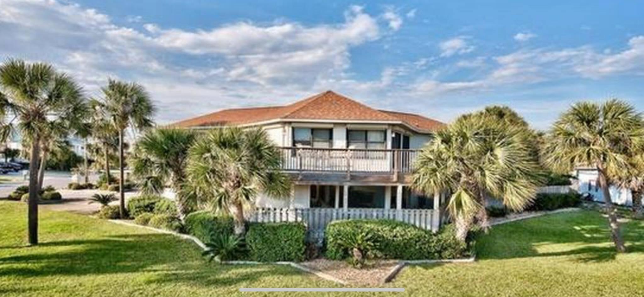 Upon entry, you're welcomed by a beautifully remodeled kitchen with custom cabinetry, stainless steel appliances, granite countertops, and a generous 8x11 island. The open floor plan flows seamlessly through the living and dining areas to a wrap-around deck with Gulf views and direct beach access across the street. The master suite features hardwood floors, split vanity, and a large walk-in shower, while the guest suite offers an en suite bath and Gulf views. Downstairs, a private studio with kitchenette and bath opens to the pool and covered patio. Enjoy your backyard oasis with lush landscaping, an in-ground pool, and over 1,000 sq. ft. of porches on a .37-acre lot just steps from the Emerald Coast.