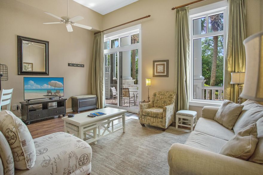 A rare find, this beautifully updated ground floor residence is conveniently located to all of the amenities with no elevator involved. Featuring 12' ceilings, walkout patio and an abundance of natural light this condo has been updated with plank wood tile flooring, modern lighting, and quartz counter tops in kitchen and bathroom vanities. The kitchen is equipped with stainless steel appliances, tile backsplash,  and a breakfast bar. A sleeper sofa and additional full bath assist to accommodate extra guests. The master bedroom has a king size bed and en suite bath with double vanity. An owner's closet and storage cage allow for ample storage. Grand Sandestin owners enjoy the resort style pool, spa, and kiddie pool, as well as the grilling area and fitness center