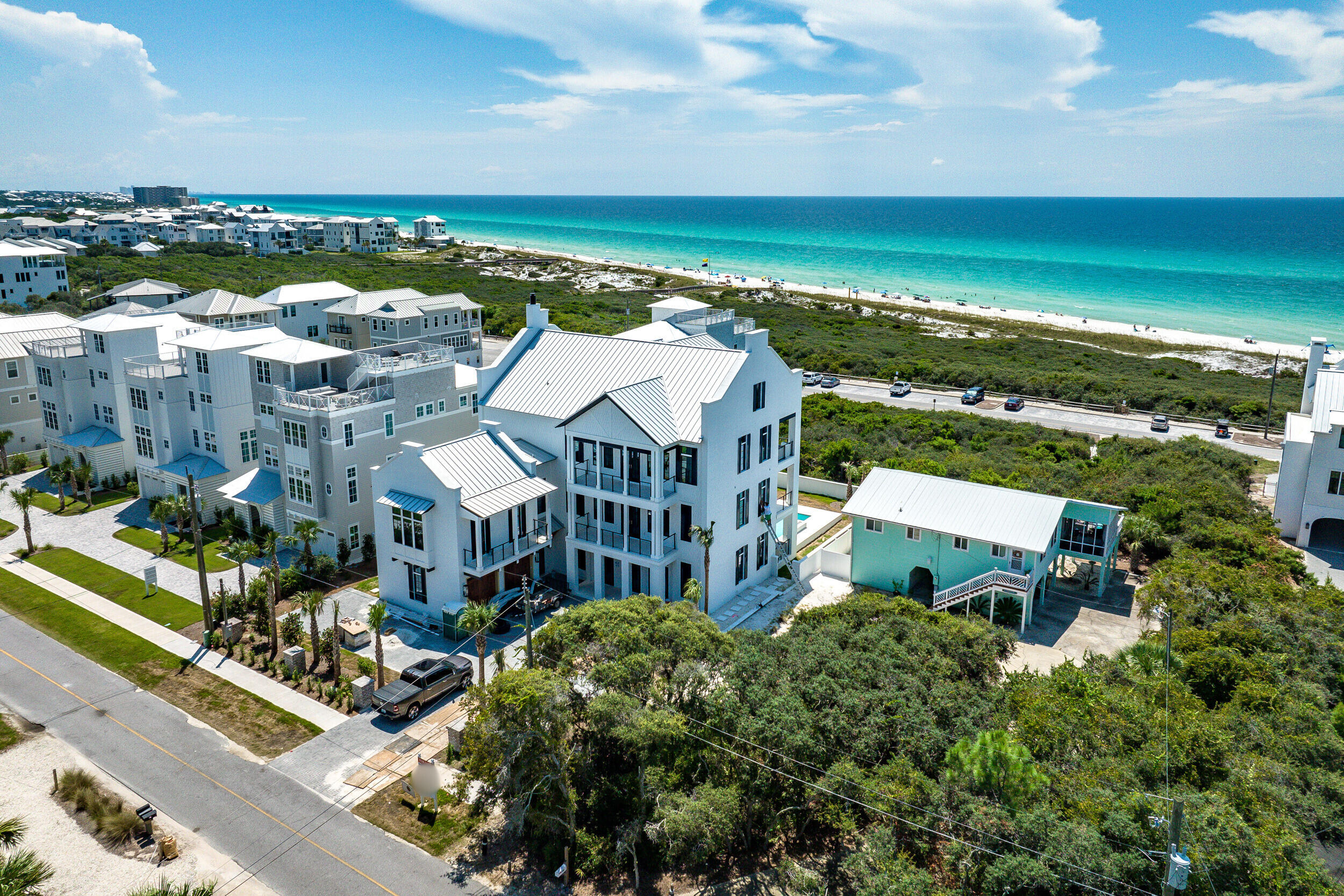 Discover unparalleled luxury just moments from the Gulf at 73 Pompano Street in Inlet Beach--an exceptional 8-bedroom, 9.5-bathroom estate crafted to surpass expectations. Designed by renowned architect Chris Stoyles of Archiscapes and showcasing interiors curated by Heather Wilcox of Wilcox Designs, this residence elegantly blends contemporary sophistication with timeless coastal charm. Spanning over 7,500 sq. ft. of interior space and more than 4,500 sq. ft. of outdoor living areas, this home embodies coastal living at its finest. Upon arrival, a brick-paver driveway leads to an attached two-car garage and refined entryways. Inside, the first floor features a welcoming living area accented by warm wood ceilings, seamlessly connected to an entertainer's outdoor haven. Highlights include a secondary kitchen with custom cabinetry, fridge/freezer, ice maker, and drink cooler, ideal for large gatherings. A versatile lounge, private first-floor primary suite, and an additional full bathroom directly accessible from the pool provide exceptional convenience. A spacious laundry room equipped with dual washers and dryers further enhances practicality. A private elevator conveniently connects the first three levels.

Step outside into a lushly landscaped sanctuary enhanced by ambient lighting, designed for privacy. Central to this backyard oasis is an impressive 30 x 26-foot heated pool, featuring a tanning ledge, deep-end bench, and a captivating fire-feature waterfall, one of the area's most notable residential pools. Complementing the pool is a luxurious 16 x 9-foot covered spa, perfect for relaxation. The expansive pool deck includes a gourmet outdoor summer kitchen with premium appliances, creating an ideal setting for sophisticated entertaining or leisurely afternoons under the Florida sun.

The second floor offers tranquility, anchored by the luxurious primary suite, a sanctuary designed for rejuvenation. This elegant space includes a spa-inspired bathroom with a tiled shower, soaking tub, rainmaker shower head, bench seating, and private washer and dryer. Three additional south-facing bedroom suites offer balcony access with breathtaking Gulf views and en suite bathrooms with custom tile showers, providing optimal comfort and privacy. Two additional bedrooms with built-in bunk beds, dedicated bathrooms, and balconies offer flexibility for guests and larger families.

The third floor showcases the heart of the home, a refined entertainment area offering panoramic Gulf vistas. An open-concept layout, crowned by vaulted wood-beam ceilings and centered around a floor-to-ceiling tiled fireplace, is filled with natural light through expansive windows and glass doors. The gourmet kitchen, featuring premium Monogram appliances, dual refrigerator/freezers, a butler's pantry, and a striking waterfall island, integrates effortlessly with spacious living and dining areas, suitable for both intimate dinners and grand celebrations. A conveniently located half bath complements this floor. A sophisticated private bar with custom cabinetry, dual drink coolers, ice maker, and wine storage enhances every gathering. Step onto the expansive covered porch featuring a second fully equipped summer kitchen and cozy gas fire pit, ideal for memorable alfresco dining.

Ascend to the fourth floor, an exclusive retreat featuring a private suite, versatile entertainment space with six built-in bunks, perfect for hosting groups or retreats and a large covered balcony offering stunning Gulf views for peaceful reflection or intimate gatherings.

Throughout the home, elegantly framed televisions and an integrated Sonos surround sound system elevate your entertainment experience. Additional amenities include three tankless hot water heaters, Mitsubishi AC system for more individualized climate control and exterior finishes featuring white-painted brick and fiber cement siding, complemented by a metal roof. Modern technology and energy-efficient features ensure exceptional comfort and convenience.

Perfectly positioned near Rosemary Beach, Alys Beach, and premier shopping and dining at 30Avenue, this fully furnished, rental-ready home is ideal for immediate occupancy or investment. 73 Pompano Street is the perfect choice for discerning buyers seeking a personal sanctuary, prestigious corporate retreat or  investment opportunity.