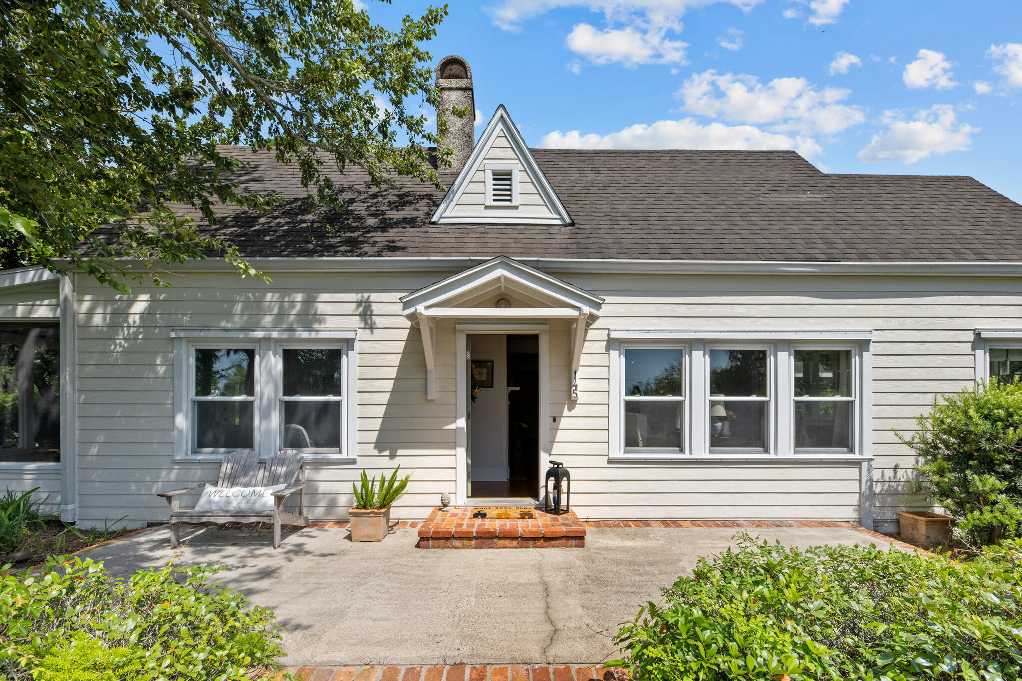 Welcome to 145 Bay Avenue - an authentic Florida cottage nestled in the heart of Apalachicola's Historic District. This charming 2-bedroom, 2-bath home sits on a spacious 1/3 of an acre lot just steps from the Apalachicola Bay and a short walk to downtown shops, restaurants, and waterfront parks. Inside the home, you'll find heart pine floors, gorgeous bay views, and vintage touches throughout. The living spaces are light and bright, with large windows that bring in the coastal breeze. The updated kitchen offers modern convenience while keeping the character of the original home intact. The guest bedroom shares a full bath, while the Primary suite includes a private bath and sitting area that opens to the side porch. Enjoy morning coffee or afternoon coctails on the generous screened in porch with bay views or gather with friends in the backyard shaded by mature oaks. The oversized lot provides room to garden, expand, or even add a guest house (with city approval). A spacious carport offers covered parking with a separate workshop with running water and electricity. Whether you're searching for a full-time residence, weekend getaway, or investment opportunity, this lovingly maintained home offers the ideal blend of location, history and charm. Don't miss your chance to own a piece of Old Florida just a stone's throw from the bay.