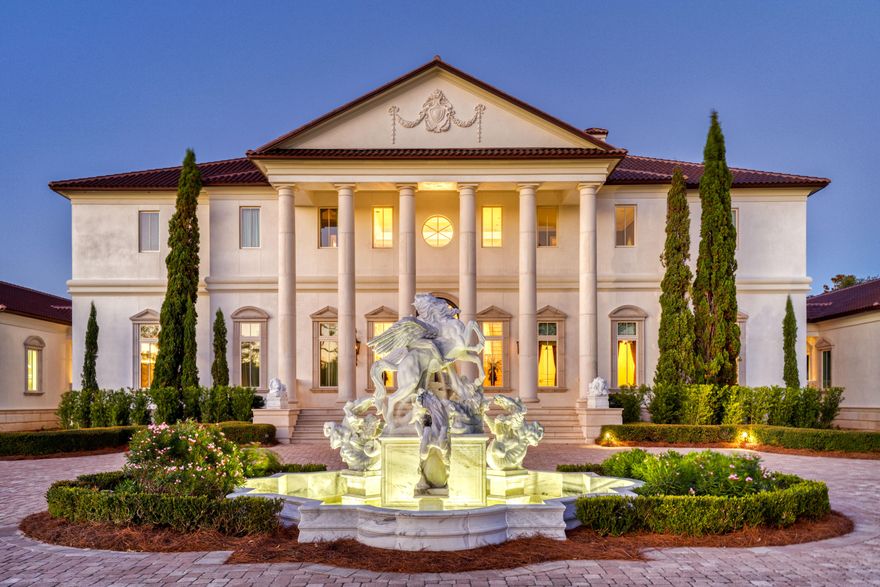 Perched on 380 feet of pristine West Bay waterfront along the Northwest Florida Gulf Coast, Villa Chimera is the most extraordinary luxury estate in Panama City Beach. Spanning 9,473 sq. ft. across three expansive lots, this 5BR/6BA/4HB masterpiece was authentically modeled after an Italian Venetian Palazzo -- designed by architect Philip Spann from hand-sketched owner drawings inspired by Renaissance master Andrea Palladio. Every finish was sourced from Italy or crafted by world-renowned artisans: a hand-carved Italian marble fountain, cushion-cut marble walls, Venetian silk upholstery, a Rome-crafted stone dining table, and a Renaissance fresco ceiling hand-painted by artist Jody Matokovich. This is not simply a Gulf Coast luxury home -- it is a one-of-a-kind legacy estate. The soaring foyer commands immediate attention with its grand Schonbek crystal chandelier, custom compass rose marble floor inlay, and solid stone staircase with marble balusters. The great room overlooking West Bay features a marble fireplace, limestone accents, and walls upholstered in Bevilacqua silk -- made in Venice and renowned worldwide. A media room with a theater-size projection screen and theatrical lighting flows seamlessly from the living space.
The gourmet kitchen features Wolf and Sub-Zero appliances, a breakfast bar, separate bar area, and a fully equipped butler's pantry for effortless large-scale entertaining. All cabinetry was custom-designed by Design Galleria of Atlanta. The dining room centers around a custom stone table crafted in Rome outside the Vatican walls, beneath Venetian watermark plasterwork evoking centuries of Palazzo history.
The second-level master suite is a private sanctuary with bay views, a columned balcony, and a hand-painted Renaissance fresco vault ceiling. Separate his-and-hers bathrooms each feature heated floors and double showers with body jets. A detached guest house -- connected by covered walkway -- includes a full kitchen, sitting area, private veranda, and full bath.
Smart home living is delivered via a full Crestron system controlling all lighting, media, and security. Additional highlights: Kohler 100KW whole-house generator, all-copper plumbing, 4-car garage with wheelchair lift, whole-house central vacuum, monitored security cameras, LED lighting throughout, and all windows and exterior doors replaced post-Hurricane Michael. A rare and irreplaceable Florida Gulf Coast waterfront estate -- schedule your private showing today.
