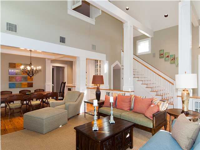 The immaculately kept interiors of this single-owner, Victor Bowman-designed and built WaterColor home hi-light the impeccable craftsmanship that can be found throughout. Stunning Australian cypress hardwood floors lay the foundation for the principal living areas and each bedroom. The beamed cathedral ceiling in the living room not only creates an inviting atmosphere but space to display artwork over the gas fireplace, flanked by built-in cabinets. Handsome wood columns create definition within the open space between the living room and the dining room, whose coffered beam ceiling is joined by a wet bar with copper sink and wine cooler. Off a private corner of the dining room is a secluded office with functional built-in desk as well as attractive display shelving and storage cabinets.