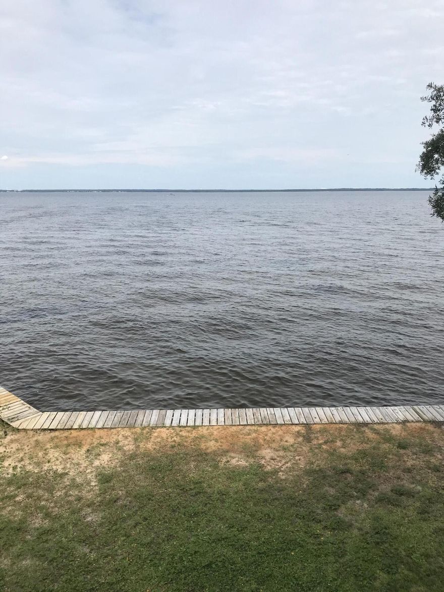 Rare to the Market, this ''Old Destin'' Bay-Front Lot/Home with 80 feet of beautiful emerald green deep water shoreline with seawall.  The 80' X 530' (.75 Acres) property is very ''private'' consisting of many incredible Oak Trees.  There is also a Key West Style 2-Story Home built in 1987 on the property which is 2,670 SF with 4-Bedrooms & 3.5-Bathrooms.  The home has some really nice upgrades so would be a great home to occupy/rent while Development Plans for the property are being completed.  There is also a detached garage.