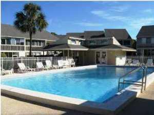 This unit and complex is quiet and a short walk to the beach with a community pool. The unit has open living on the main floor with views of the pool and landscaping. Two patios and open living in the unit. Both Bedrooms are upstairs. The master bedroom has vaulted ceilings.