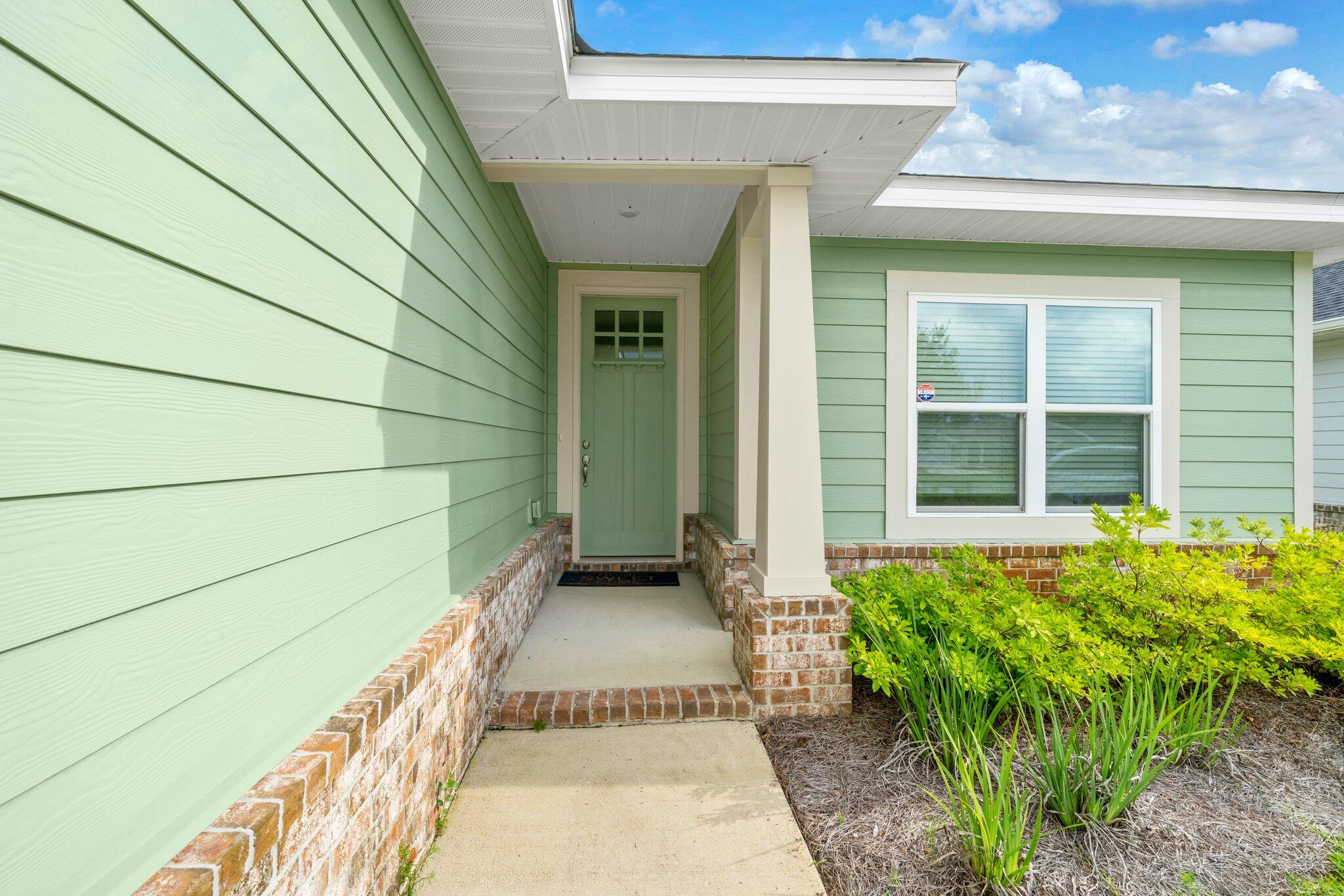 SOUTH of Highway 20, AVOID THE TRAFFIC and available to Least to Purchase. This beautiful 3-bed, 2-bath home, located in the desirable Riverwalk Subdivision--just a 15-min drive to Blue Mountain Beach! Step inside to find 9' minimum ceilings throughout, with a vaulted ceiling in the Great Room and a Trey ceiling in the Master Bedroom. The 8' entry doors, granite countertops in the kitchen and baths, and CoreTec Pro Plus vinyl plank flooring in the main living for durability and elegance. The cozy bedrooms feature plush carpet, while the huge walk-in master closet ensures ample storage. Enjoy the outdoors with a large covered back porch with an easy to maintain back yard. Garage floor painted and has a mini split to allow comfort cooling in the garage.