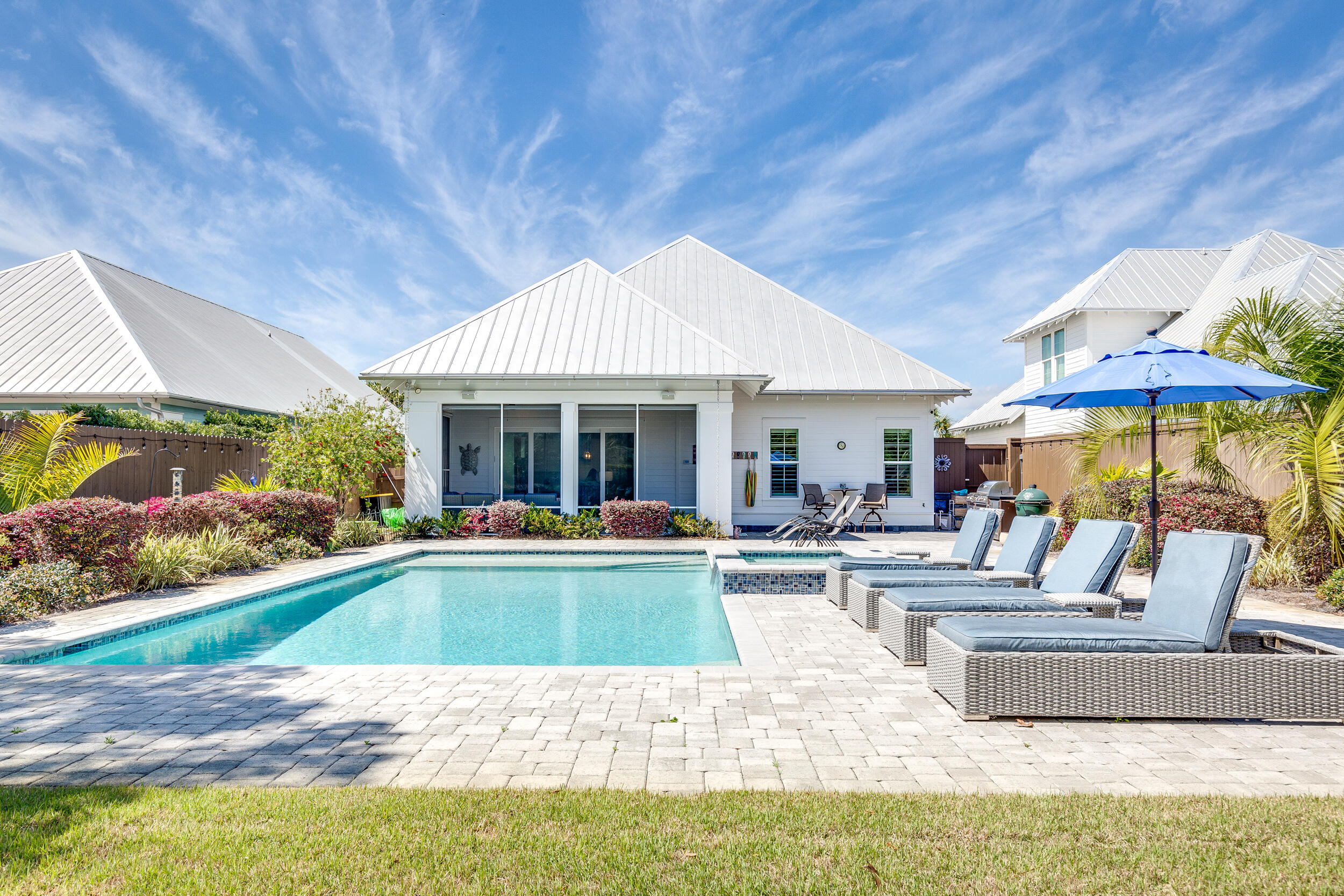 This is not your typical postage stamp beach lot- this almost 1/2 acre lot has been landscaped to perfection for the ultimate backyard oasis. Homes on this street do not come on the market often at all- now's your chance to own in this rental restricted community. Less than 1/4 mile to the beach and all the fun that Gulf Place has to offer. Offered fully furnished & ready to enjoy. As you walk through the front door you are greeted by beautiful, light wood floors and white ship lap walls. This thoughtful floorplan allows for mostly first floor living- with owner's suite, and 2 additional bedrooms with baths on one floor. The chef's kitchen is laid out such that you can have multiple cooks in the kitchen at one time around the oversized square island.