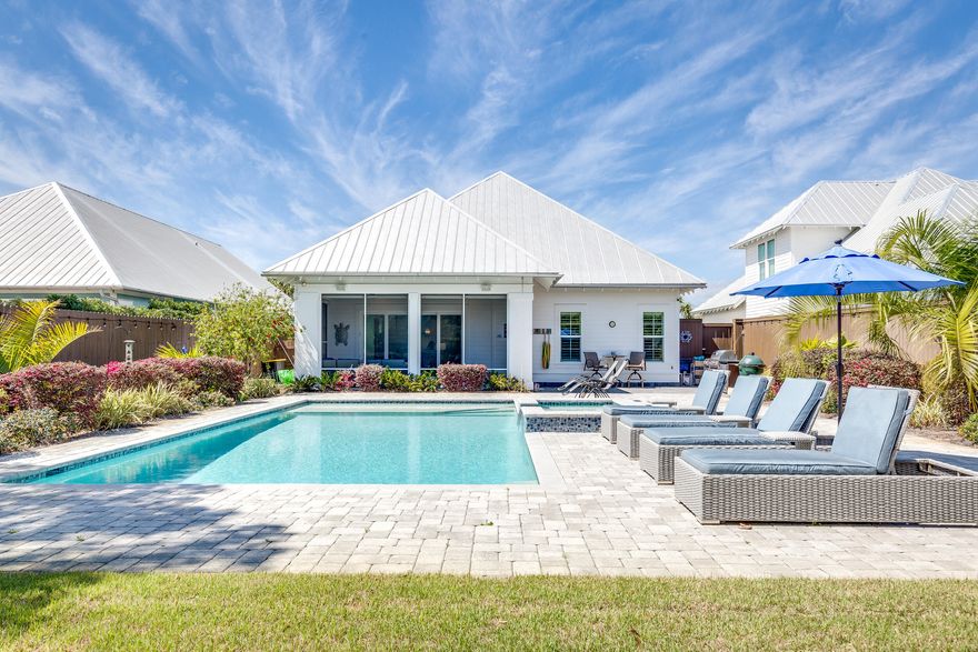This is not your typical postage stamp beach lot- this almost 1/2 acre lot has been landscaped to perfection for the ultimate backyard oasis. Homes on this street do not come on the market often at all- now's your chance to own in this rental restricted community.  Less than 1/4 mile to the beach and all the fun that Gulf Place has to offer.  Offered fully furnished & ready to enjoy.  As you walk through the front door you are greeted by beautiful, light wood floors and white ship lap walls. This thoughtful floorplan allows for mostly first floor living- with owner's suite, and 2 additional bedrooms with baths on one floor.   The chef's kitchen is laid out such that you can have multiple cooks in the kitchen at one time around the oversized square island.
