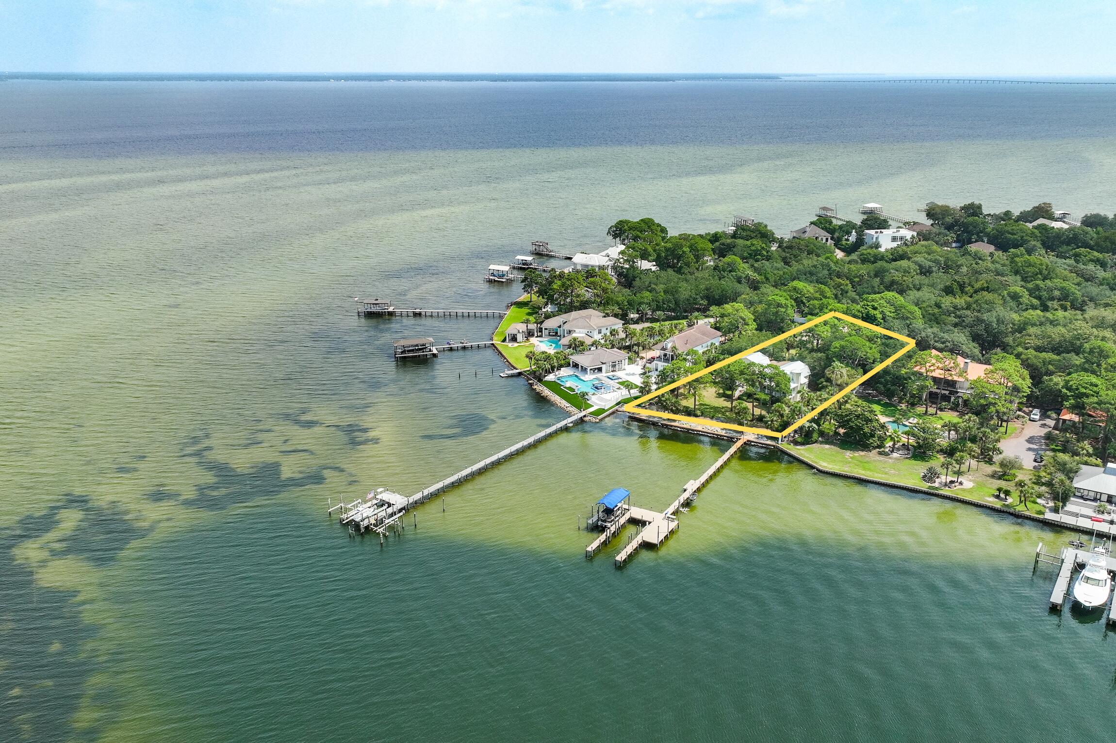 This PRIME property is situated on an estate sized lot and quiet cul-de-sac, with 165 feet of water frontage at the mouth of deepwater Joe's Bayou and Choctawhatchee Bay. A gentle curving driveway leads to an impressive entrance reminiscent of a Key West Home with expansive water view from main living area, including the kitchen and dining room. This home features refinished solid wood floors, granite Kitchen countertops, large wet bar off main living area featuring a Wine Cooler, Ice Maker, & cabinets. Luxurious master bath with travertine, Jacuzzi tub, walk-in shower, outdoor CalderaSpa, Indoor/Outdoor surround sound Sonos System, and 2 car garage. One bedroom ground residence. Upgraded Dock to boathouse & slip. DEEP WATER ACCESS & TRULLY MAGNIFICENT SUNSET