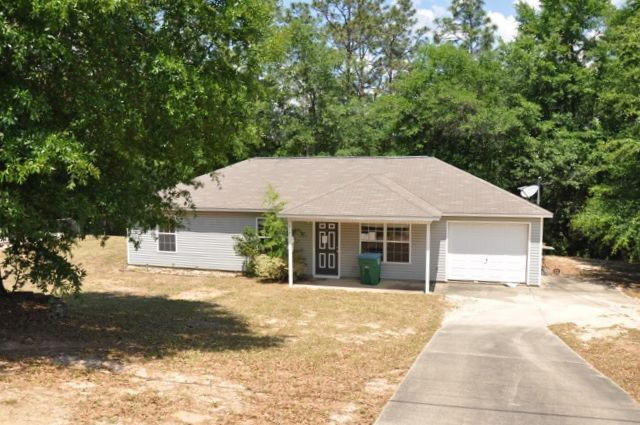 REO. Located in the heart of Crestview, this home has a lot to offer! Home features vinyl siding, 1-car garage, and is located on half an acre lot. The backyard includes an open patio and backs up to nature, so you can have some privacy while grilling and enjoying the outdoors! Inside the home you have a vaulted ceiling in the living room and tile can be found in all wet areas. Home is located within minutes of Bob Sikes Elementary School and is close to Duke Field. Being sold AS IS.