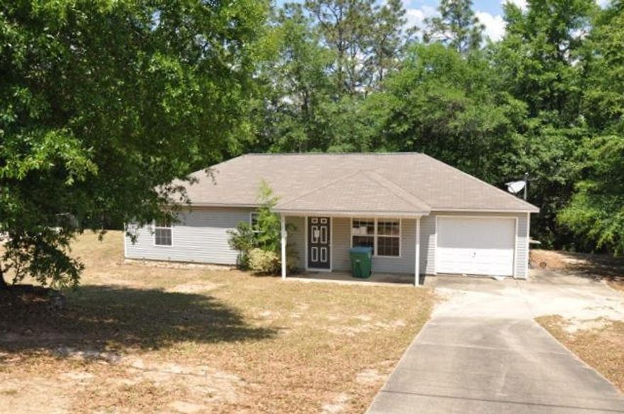 REO. Located in the heart of Crestview, this home has a lot to offer! Home features vinyl siding, 1-car garage, and is located on half an acre lot. The backyard includes an open patio and backs up to nature, so you can have some privacy while grilling and enjoying the outdoors! Inside the home you have a vaulted ceiling in the living room and tile can be found in all wet areas. Home is located within minutes of Bob Sikes Elementary School and is close to Duke Field. Being sold AS IS.