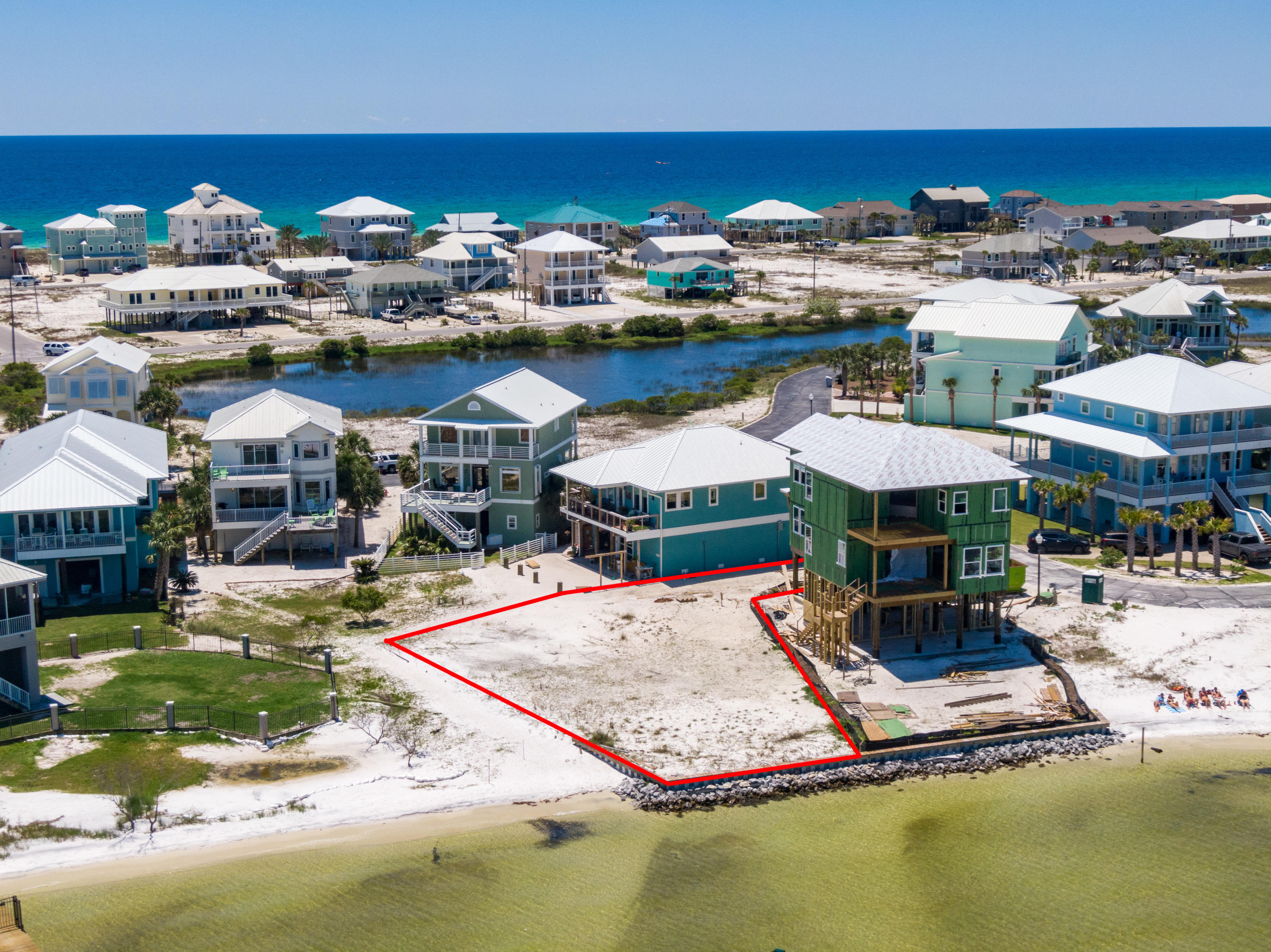 The Perfect waterfront lot overlooking Santa Rosa Sound with over 50 feet of frontage and a seawall already in place. Pristine white sand covers the entirety of the lot which features a new seawall and rip rap in addition to the community conservation area to the West. The seller has added a substantial amount of sand to the lot and water tap fee is already paid! Build your dream home and step out to your own private white sand beach, perfect for swimming, sunbathing, fishing, boating, jet skis, kayaking and other water activities. Enjoy watching the breathtaking sunsets and sunrises over the calming waters of the Sound. Caribbean Isles community is Private and Gated, with a pristine community Pool, lighted Tennis Courts, Sauna, Street Lights and Underground Utilities ... Navarre Beach is one of the last places with the old Florida feel and is home to Florida's Longest Fishing Pier. Enjoy Crowd free beaches, Emerald green waters and miles of Sugar White Sandy Beaches, walking & biking trails, a fishing pier, Gulf Island National Seashore to the west and county owned park to the east for ultimate in privacy and leisure.
