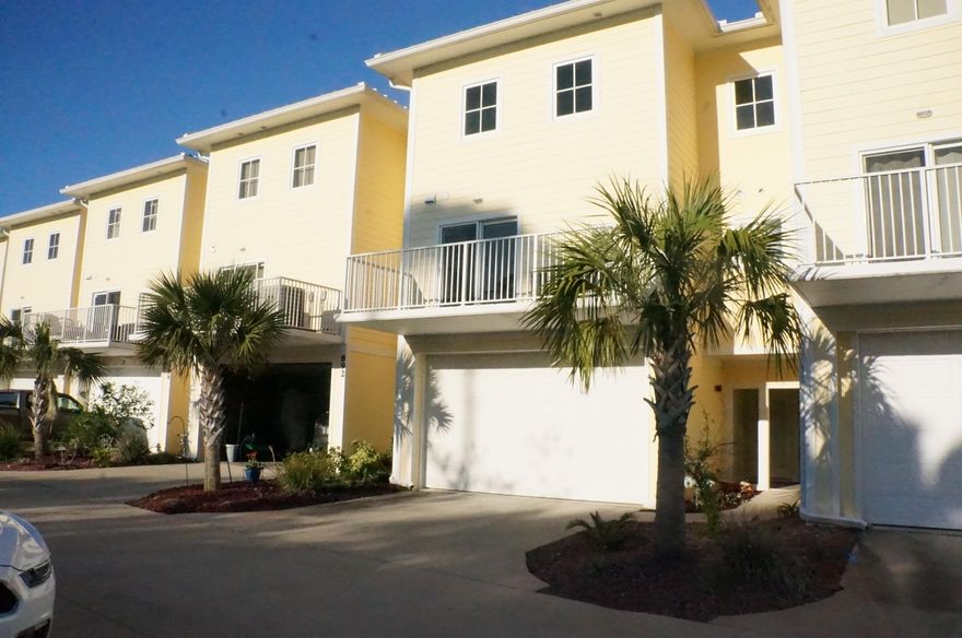 Picturesque water views from nearly every room! This stunning NEVER LIVED IN 3/3 town home features high end custom finishes from bottom to top! Exteriors were constructed in 2008, but from frame in all construction is brand new! Kitchen is equipped with gas range, gorgeous wood cabinetry, granite countertops, stainless appliances & ample sized pantry. Breakfast bar flows through to dining/living areas with water views and full length covered balcony. Easy to maintain wood look tile flooring in social areas. The master bedroom is thoughtfully appointed with rich wood flooring, indirect lighting, seating area large walk in closets and wall inset for tv. Enjoy beautiful views of the Sound and Pensacola Beach while lying in bed or relaxing on the covered balcony.