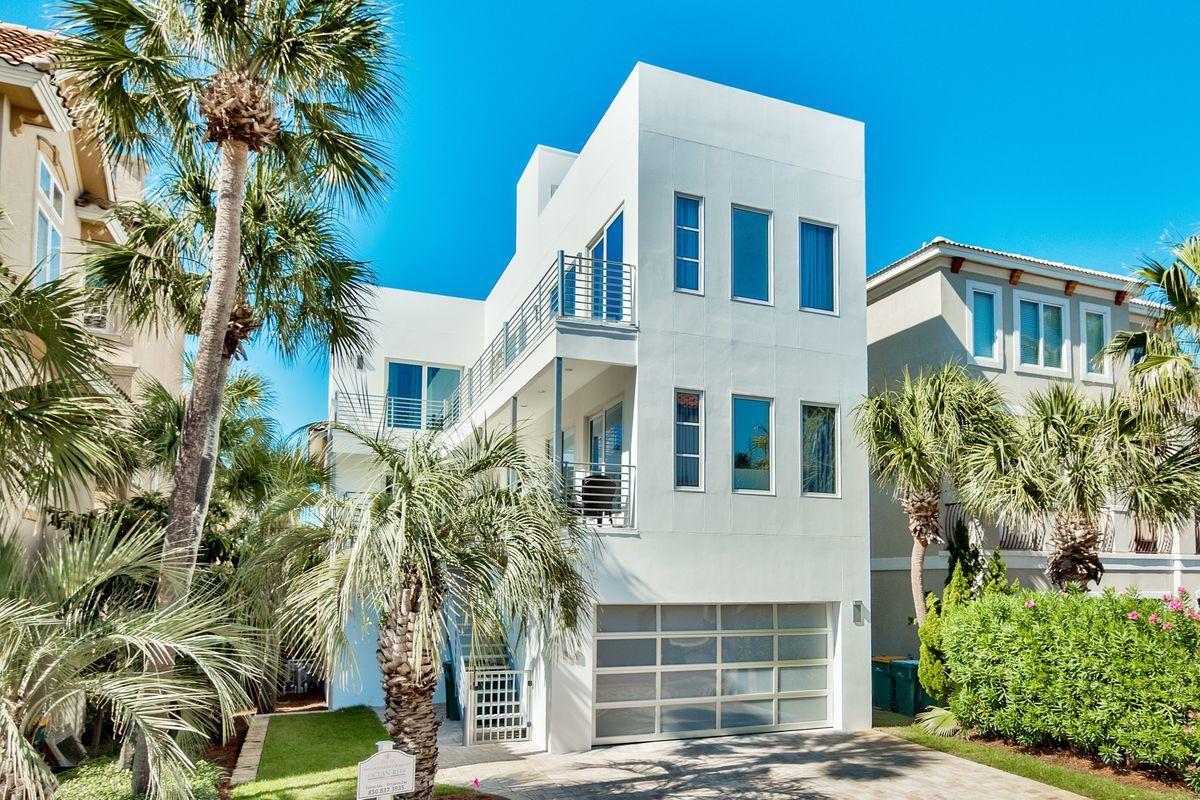 Striking ultra-contemporary construction primely located in the prestigious gated community of Destiny by the Sea this five bedroom home is perfectly poised to capture sweeping gulf views defined by an iconic modern architectural design profile. This home has exceptional short term rental opportunity with notable features including an elevated pool deck located on the second level of the home with gorgeous peacock pavers and ample space for entertaining.The stylish interior design is defined by professional modern decor, clean lines and artistic accents creating a fun, vibrant atmosphere that characterizes the functional open floor plan.