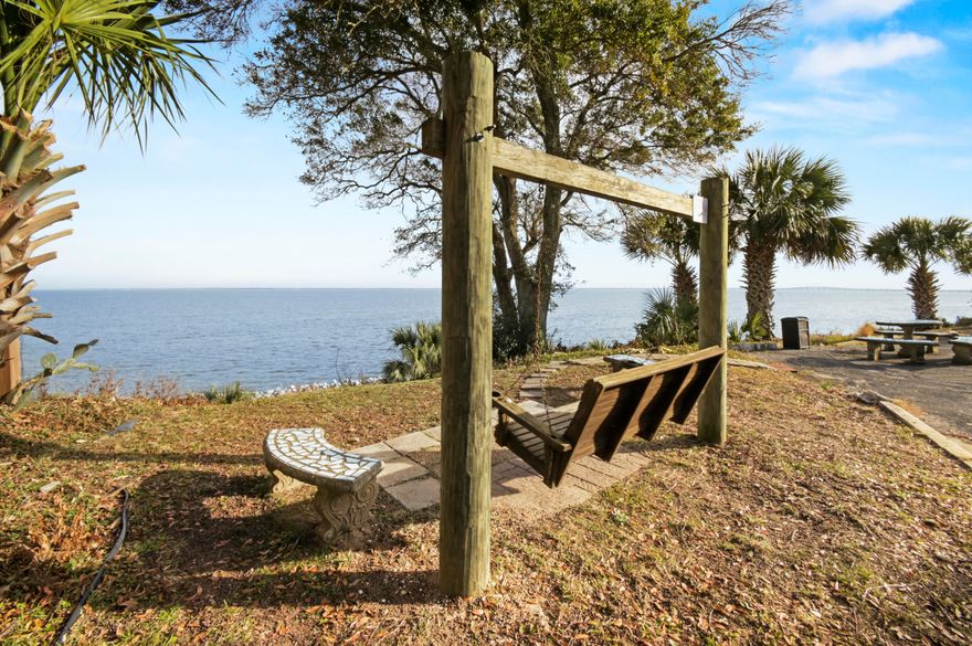 WATERFRONT LIVING! Welcome home to this turn-key condo with stunning, unobstructed VIEWS OF PENSACOLA BAY! Stepping into this spacious 2 bedroom / 1.5 bath condo you'll immediately feel the abundance of warm, natural light brightening the central living space. Looking around you'll notice upgrades such as NO CARPET throughout, crown moulding, chair railing, and fresh neutral paint. The kitchen is a chef's dream offering stainless steel appliances, a cut-out opening the space up, decorative mediterranean tile work, bright white cabinetry, and plenty of storage. The two bedrooms can easily accomodate king beds, with the larger bedroom offering an en-suite half bath. Both bedrooms offer VIEWS OF THE BAY from their windows! The full bath in the hallway features a deep bath - perfect for relaxing after a long day or for those with kids. Concrete walls between units ensure peace and quiet between neighbors! This waterfront community features a beautiful courtyard adorned with palm trees, massive pool, elevators, manicured landscaping, security cameras, and a recently upgraded laundry room. The crown jewel of this community is the waterfront seating area, allowing you to unwind after a long day and take in the scenic Florida sunsets. Make this condo your home, and live your waterfront dream! 