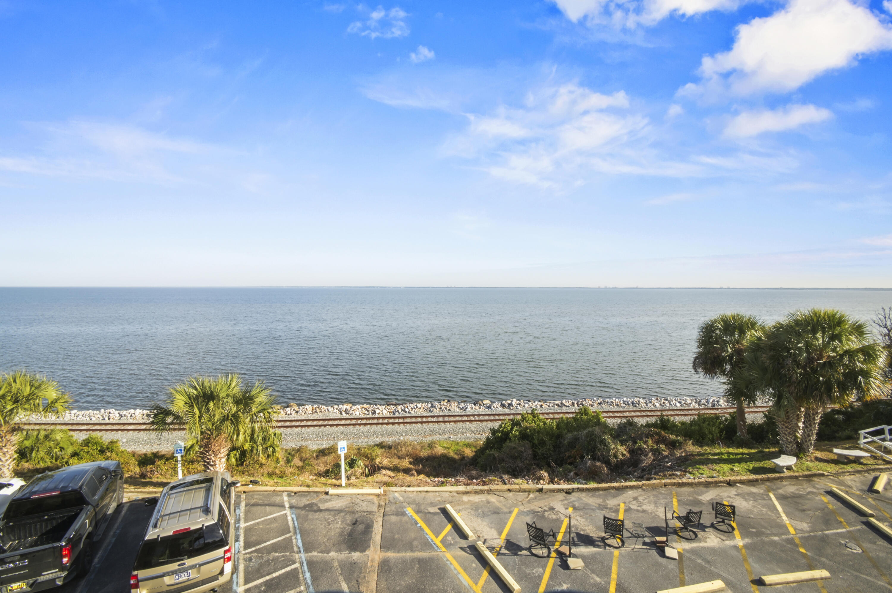 WATERFRONT LIVING! Welcome home to this turn-key condo with stunning, unobstructed VIEWS OF PENSACOLA BAY! Stepping into this spacious 2 bedroom / 1.5 bath condo you'll immediately feel the abundance of warm, natural light brightening the central living space. Looking around you'll notice upgrades such as NO CARPET throughout, crown moulding, chair railing, and fresh neutral paint. The kitchen is a chef's dream offering stainless steel appliances, a cut-out opening the space up, decorative mediterranean tile work, bright white cabinetry, and plenty of storage. The two bedrooms can easily accomodate king beds, with the larger bedroom offering an en-suite half bath. Both bedrooms offer VIEWS OF THE BAY from their windows! The full bath in the hallway features a deep bath - perfect for relaxing after a long day or for those with kids. Concrete walls between units ensure peace and quiet between neighbors! This waterfront community features a beautiful courtyard adorned with palm trees, massive pool, elevators, manicured landscaping, security cameras, and a recently upgraded laundry room. The crown jewel of this community is the waterfront seating area, allowing you to unwind after a long day and take in the scenic Florida sunsets. Make this condo your home, and live your waterfront dream! 