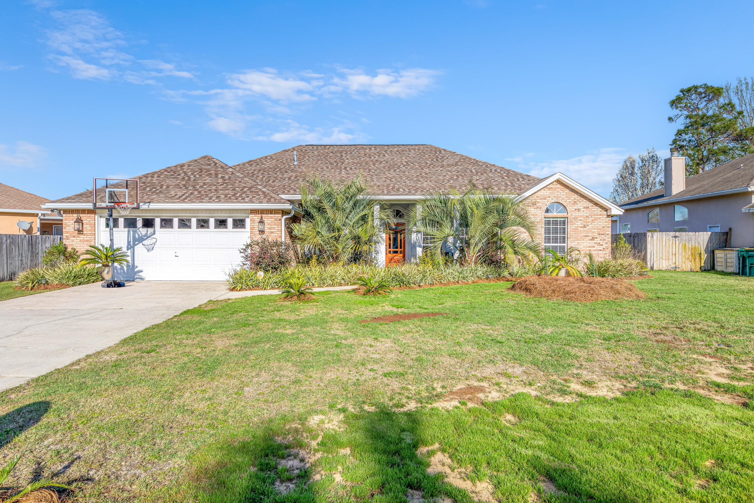 The one you have all been waiting for! Not a single inch was missed in this gorgeous completely remodeled 4 bedroom 2 bathroom home located in Raintree Estates, close proximity to everything Destin has to offer. Entering this home you will be welcomed by a large open living concept to include a formal dining area, a brick gas fireplace, white shaker walls in the kitchen with peninsula cabinets dressed with beautiful marble counter tops. Black Stainless steal appliances and travertine tiled floors to insinuate the well designed kitchen. This home has no carpet, hardwood floors lay throughout the entire home! The split bedroom plan offers enough living for a large family, both bathrooms also include travertine tiling and marble counter tops. If this home doesn't already have it all