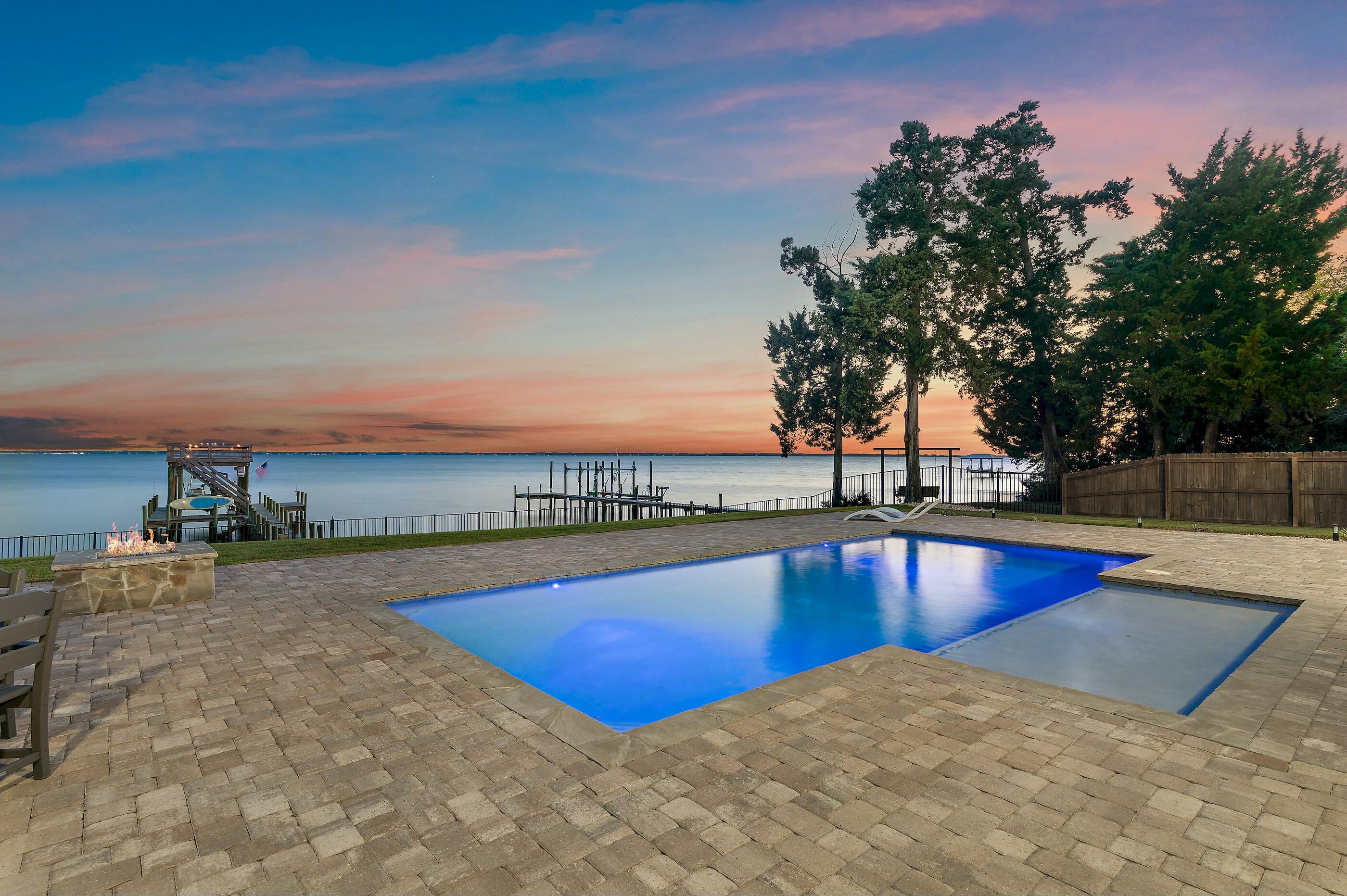 Absolutely Stunning Bayfront Estate featuring immaculate 2022 Coastal Farmhouse construction on coveted Red Barn Road in Flood Zone X. 4 Bed/4.5 Bath with detached garage, pool, yard, dock spanning .66 acres with 100' of Bay frontage. The spacious private drive with ranch style fence welcomes you into the serene beauty of pristine Bayfront living offering tranquility and space to live your best life without the confines of an HOA. Gorgeous front elevation with custom Coastal Farmhouse design greets you with a warm from porch featuring tongue and groove ceilings and a hurricane proof front door that will blow you away with its glamor and stature. The Southern charm blends Coastal elegance as you enter the home. French Oak hardwood floors span the downstairs open living concept with raised coffered tongue and groove ceilings projecting natural light onto shiplap wall feature from Bayview windows
The kitchen features Calacatta Borghini Quartz countertops throughout with shiplap accented island featuring a farm sink with bronze gooseneck pulldown and disposal. Marble backsplash with recessed lighting, custom cabinetry, gas stove with hood, double oven and stainless steel appliances. Quaint dining area with canned downstairs lighting offers pool and Bay views and access to back porch and grilling area. Convenient half bath with Pottery Barn marble vanity and oversized mudroom with quartz sink with washer and dryer offer direct access to exterior porches. Interior kitchen corner features huge walk-in pantry.
Master Bedroom downstairs offers beautiful Bay views and door to back porch hot tub. Master Bathroom features custom Pottery Barn marble vanity, freestanding tub, large shower area, and Alaskan white herringbone porcelain tile and oversized walk-in closet.
The front of the house features a 2nd downstairs bedroom with bathroom featuring Pottery Barn marble vanity and subway-tiled shower. Work from home with a large office just off the front foyer. Upstairs features 2 bedrooms with Bay views that are on opposite sides of large upstairs living area featuring high-end wall-to-wall carpeting for comfort and an additional room for storage.
Exterior home built to last with 2x6 framed walls, hybrid shingle roof with metal accents, exposed rafter tails on all roof overhangs, and Anderson black on black windows throughout with all exterior doors hurricane rated.. Back porches offer sublime pool/bay views and all painted and sealed with tongue and groove ceilings above that feature a 6 speed fanned sitting area with television, summer kitchen with Blaze gas grille can Cavaliere vent, min-fridge, and outdoor sink. Outdoor shower and Hot Springs Hot tub offer extra convenience and comfort in this sublime oasis.
Step off the porch to a luxuriou 13'x32' pool with 6'x15' tanning ledge all built by Blue Haven pools with light features that change color. Enjoy views from the pool or gas fire pit. Zoysia grass between the Bay and pool is all irrigated using an 8 zone Rain Bird irrigation well and black aluminum fence bordering the seawall and rip-rap along 100' of private frontage along the Bay. A pier leads you from there to the boat dock featuring an 8,000 lbs. remote control Breeze boat lift accommodating up to a 32' boat with water and 220 and120 power. Water is deeper than most areas on the north shore of the Choctawhatchee Bay and allows for a convenient 5-minute boat ride to The Bay, North Beach Social and Farm & Fire restaurants. Approx. 30 minute boat ride to the Gulf and Crab Island or 45 minutes to Panama City Beach via the Intercostal waterway.
After a day on the water enjoy unlimited hot water with your Rinnai tankless water heater and cool air from your Carrier heat pump and AC safety from your ADT security system. Coastal elegance meets functionality as you go from the fenced in back yard along pavers to the front yard where you have a large 2 car detached garage with exterior gooseneck lighting and power and sink perfect for vehicles or the ultimate workshop. Conveniently located allowing you to enjoy the tranquility of of the bay, the close proximity to worlds most beautiful beaches along 30A, and shopping in a safe area.
Don't let this rare opportunity to own superior craftsmanship just built in 2022 ideally located in sought after Flood Zone X on the bay with no HOA dues. Schedule your tour and experience this sanctuary on the Bay in person before its gone!