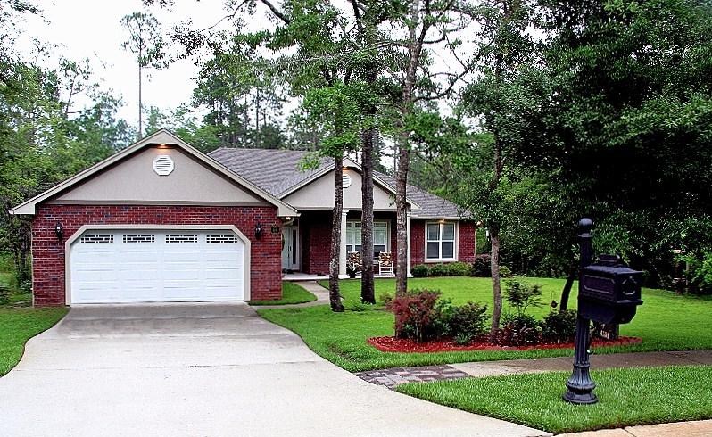 Custom Built brick home, South of I-10, with screened porch on a .65 acres, and a non-buildable buffer for privacy and creek access. Located in the highly desired neighborhood of Juniper Creek Estates. Open floor plan with a trey ceiling in the master bedroom,carpeted bedrooms, tile floors in the living area, kitchen, nook, bathrooms and formal dining room with double trey ceiling. Chefs kitchen with pendant lights, granite counter tops, stainless appliances and soft close drawers. The huge master suite has his and her walk in closets, double vanities, king sized shower and jetted tub. Upgrades galore: Creek irrigation system, foam insulated attic, heat pump water heater, storage shed, crown molding, recessed lighting,whole house entertainment system, insulated garage and garage door.
