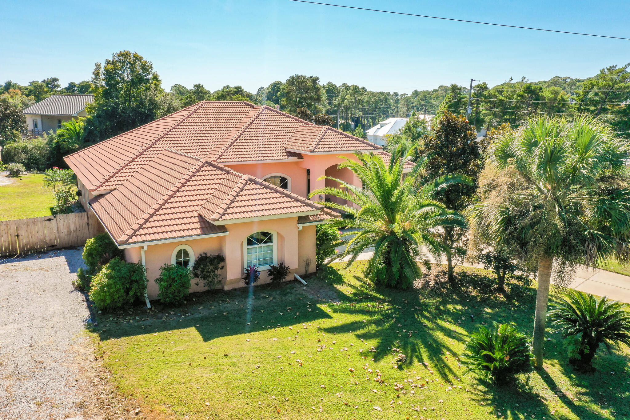 Live the 30A lifestyle and enjoy the serenity of 146 Golf Club Drive in the beautiful Dune Allen Area of 30A! A rare find as this home is located on a large corner lot, which can accommodate a large RV, Boat(s), or beach toys, and on a quiet, dead-end street having low traffic, adjacent to Santa Rosa Beach Golf and Beach Club. Enter the home through the tiled, double door entryway into an elegant arched foyer. The home is bright and airy, with 12-15-foot ceilings throughout. The living area is open to the kitchen and dining room with a view of the enclosed lanai with its beautiful sparkling salt water, heated, blue pool and fountain.   The pool and the 6-person hot tub  are enclosed in the lanai with doggy door access.   A double-sided gas fireplace is located between the living room and