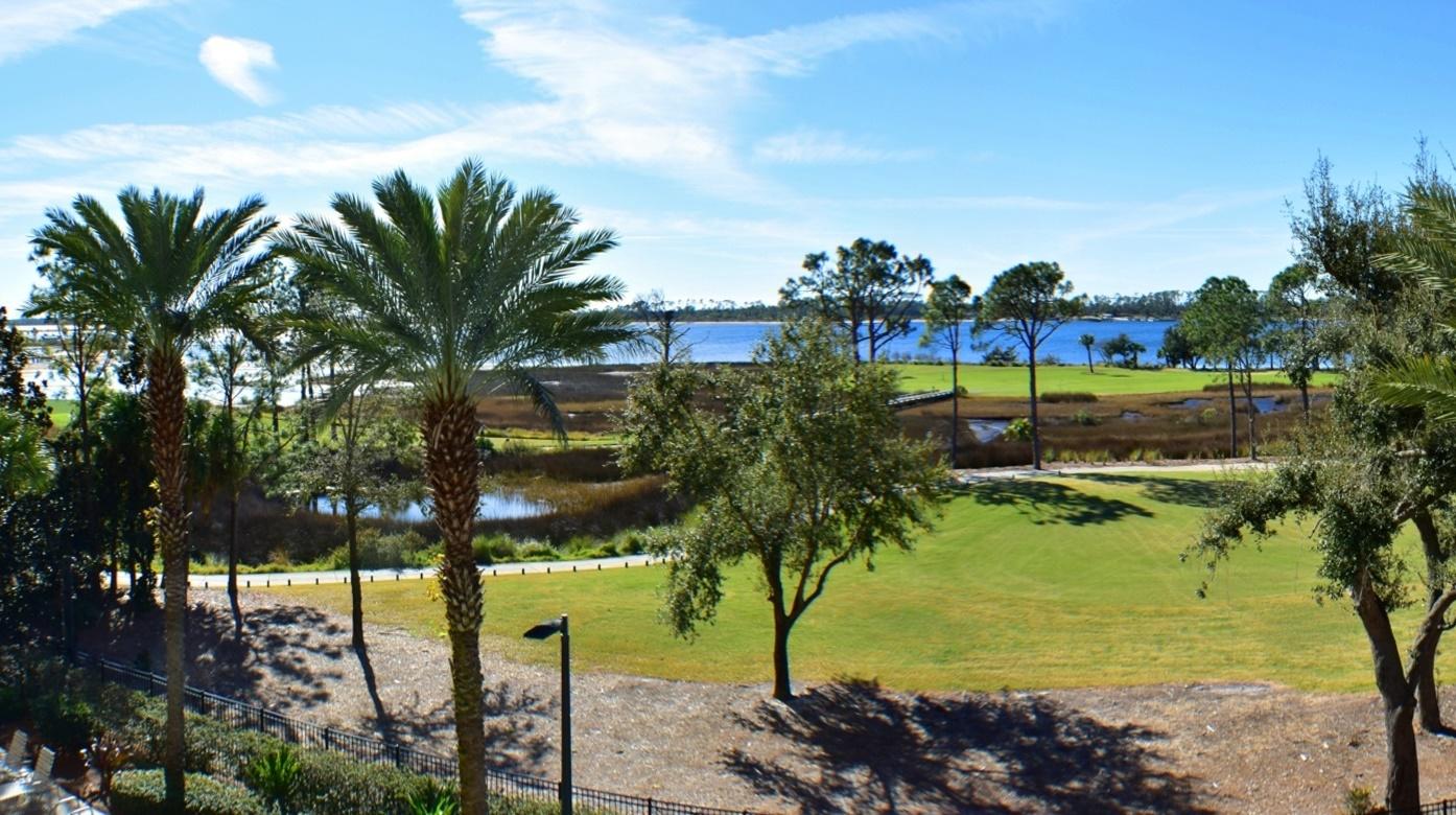 Welcome to ''The Grand Residences''! This is a 4th floor unit overlooking St. Andrews Bay, Grand Lagoon, the pool and garden area. Finely appointed 2BR/2BA condo with an office/bonus room, a separate and cooled storage unit on the same floor, and an assigned parking space. This is a furnished and move-in ready unit! You will enjoy all of the onsite amenities including a private pool, jacuzzi, fitness center, a covered rec area with fireplace, a fire pit and summer kitchen, and an owners lounge. Also, the exterior of the building was recently repainted. Bay Point is a gated community that features a Jack Nicklaus designed golf course and world-class tennis courts. All info is approx and must be verified by Buyers if important.