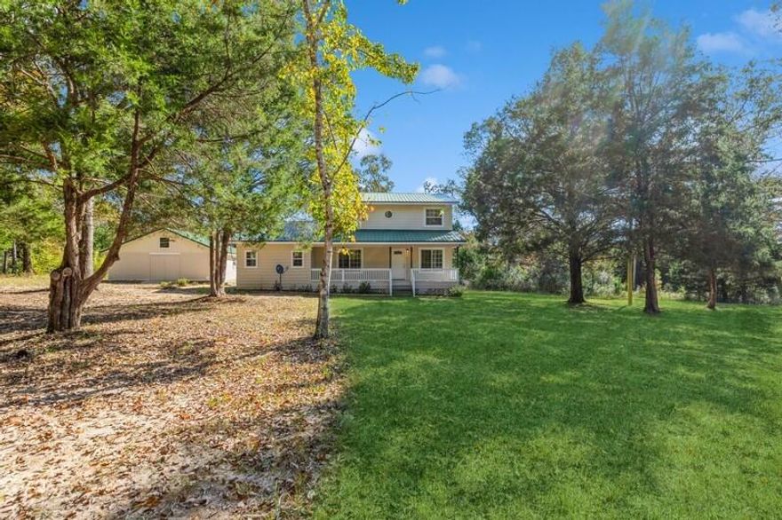 What are you waiting for? Experience the charm of country living with this enchanting farmhouse nestled on 7.65 acres in the serene Munson Community, adjacent to a sprawling 100,000-acre wildlife management area. This home has been lovingly remodeled, including a brand-new 560+ sq ft master suite that promises comfort and privacy. With no HOA and no restrictions, enjoy the freedom of rural life with the benefit of low county taxes. The inviting two-story design features a spacious living room with gleaming hardwood floors and abundant natural light. Step outside onto the classic covered front porch, perfect for a swing and hours of relaxation while soaking in the tranquil country air. This home is not merely a place to live--it's a return to a simpler, sweeter way of life. Step into a beautifully remodeled haven on the first floor, featuring a living room, formal dining, a state-of-the-art kitchen, and an office/laundry space. Not to forget the half-bath, a versatile large bonus room that doubles as a den or theater room, a practical mud room, and the stunning new master bedroom suite. The craftsmanship is top-notch with new woodwork, doors, and framing throughout. Crown molding adorns every corner, even the closets, enhancing the elegance of the space. Essential upgrades like new insulation, sheetrock, and fresh paint have been meticulously attended to. The bathrooms boast new tile flooring, sleek cabinetry, and quartz countertops, with a total of three full baths and one half bath ensuring ample convenience. The kitchen is a chef's dream with pristine white cabinets, quartz counters, and a new stainless steel appliance package that includes a large deep farm sink and a gas stoveperfect for cooking and canning. The expansive bonus room also features a cozy stove/heater for those chilly nights and built-ins that create the perfect spot for an oversized television. The master suite on this level includes a walk-in closet and a luxurious bathroom with a double vanity and an oversized walk-in shower. Direct access to a brand new deck from the suite offers a private outdoor retreat. The laundry area has also been upgraded as part of the remodel, maximizing every inch of space with clever storage solutions. Upstairs, the dream continues with three guest bedrooms, an additional master suite, and another full bath, providing ample space for family and guests. The exterior is equally impressive with a gorgeous inground pool featuring a new liner and a soothing waterfall, all enclosed in a private lanai. A large separate garage with additional rooms, a bathroom, and a loft offers endless possibilities, complete with electricity. The expansive fenced backyard and the surrounding land offer the perfect backdrop for the glamorous country lifestyle you've been dreaming of.