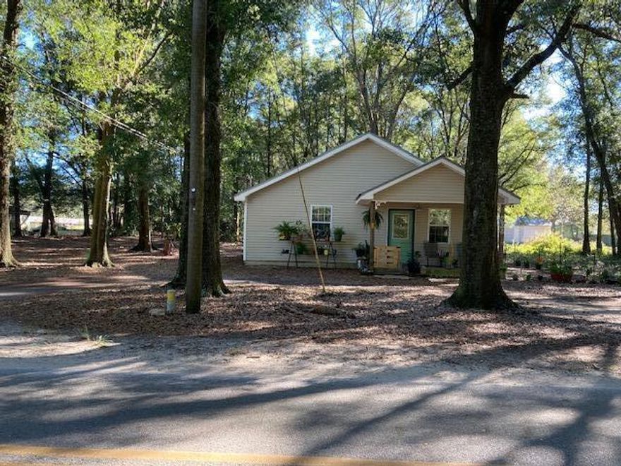 PENDING WITH MULTIPLE OFFERS!7.89 acres  of privacy surround the cutest 720 sq ft, one bed and one bath, cottage.  The bedroom has ample room for one king bed or two queen beds.  There is a washer and dryer in the hallway.  Central A/C and heat.  All electric.  New water heater installed in September 2021.  Appliances  are included (stove, refrigerator, microwave, washer and dryer.)  There is an outdoor fire pit for entertaining.  Front porch is fenced in and along the south side for small pet.  Floors are all tile and there is no grass outside to maintain.  Kitchen has hanging pot rack and windows have blinds. Property has one utility metal shed on concrete slab.  The cottage is occupied, so show by appointment only.