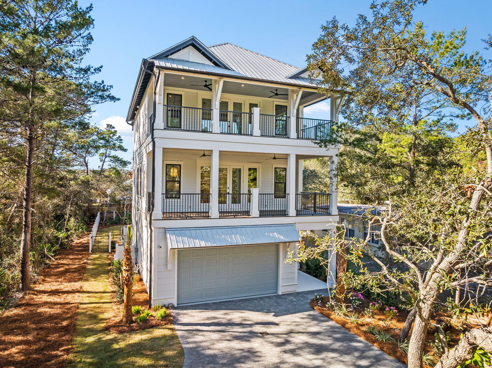 Located in the heart of Seagrove along iconic 30A, this stunning new construction home is just a half-mile from the sugar-white sands and turquoise waters of the Gulf. Ideally positioned for relaxation and entertainment, it offers easy access to public beach access, renowned dining, and the vibrant charm of 30A's coastal lifestyle.The fenced backyard is a private oasis, featuring a luxurious saltwater pool equipped with a heater and chiller, making it perfect for year-round enjoyment. The screened-in patio takes entertaining to the next level with a cozy gas fireplace, grill, kitchen, and ample space for gathering with family and friends. Whether hosting a poolside party or enjoying a quiet evening under the stars, this outdoor space is designed for making memories. The 2-car garage,complete with epoxy floors and a built-in golf cart charger, ensures convenience meets sophistication.
Step inside, and you'll be greeted by exceptional craftsmanship and thoughtful design. The first floor boasts porcelain tile floors, solid quarter doors, and a guest bedroom with a full bath and shower. A spacious laundry room with a washer and dryer adds to the functionality, and the elevator ensures effortless access to all three levels.
The second floor features an open-concept layout ideal for entertaining. The chef's kitchen is outfitted with Thermador appliances, quartz and natural stone countertops, a pantry, and a wet bar with a fridge. The living area is bright and inviting, with shiplap accents and a seamless flow to a Trex balcony. A half bath off the living area and a private ensuite bedroom with a subway-tiled shower complete this level.
The third floor offers a tranquil retreat. The master suite boasts a spacious Trex balcony and a luxurious master bath. A charming bunkroom and a full bathroom with a subway tile shower provide space for guests or family, while a second laundry area adds convenience to the upper level.
This home is packed with premium features, including three AC units, two tankless water heaters, a security system with cameras, and an irrigation system.
Whether enjoying peaceful mornings on the balcony, entertaining by the pool, or exploring all the best of 30A, this home delivers the perfect blend of sophistication and coastal charm. Don't miss your chance to own a piece of paradise in Seagrove. Schedule your private showing today!