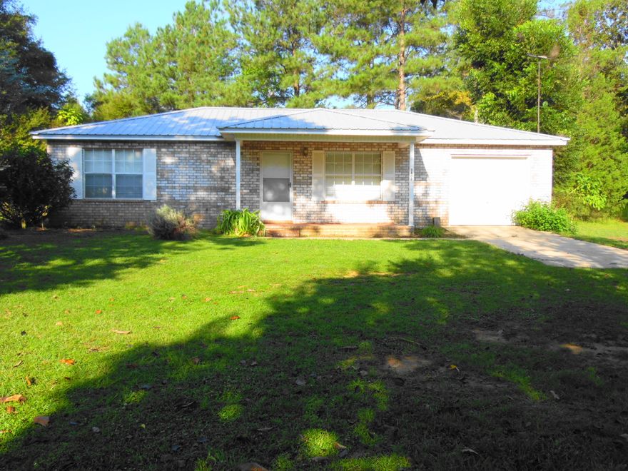 Beautiful brick home with garage on 1 acre. Built in 2000, with metal roof. This country home corners on Hwy 81 S and Pusley Road. Super location and affordability for those working at the beach. Refrigerator and stove included. Freshly repainted interior. You could easily convert the garage to additional living space and have 1446 sq. ft. By adding that 4th bedroom and 2ND bath. Easy to show.
