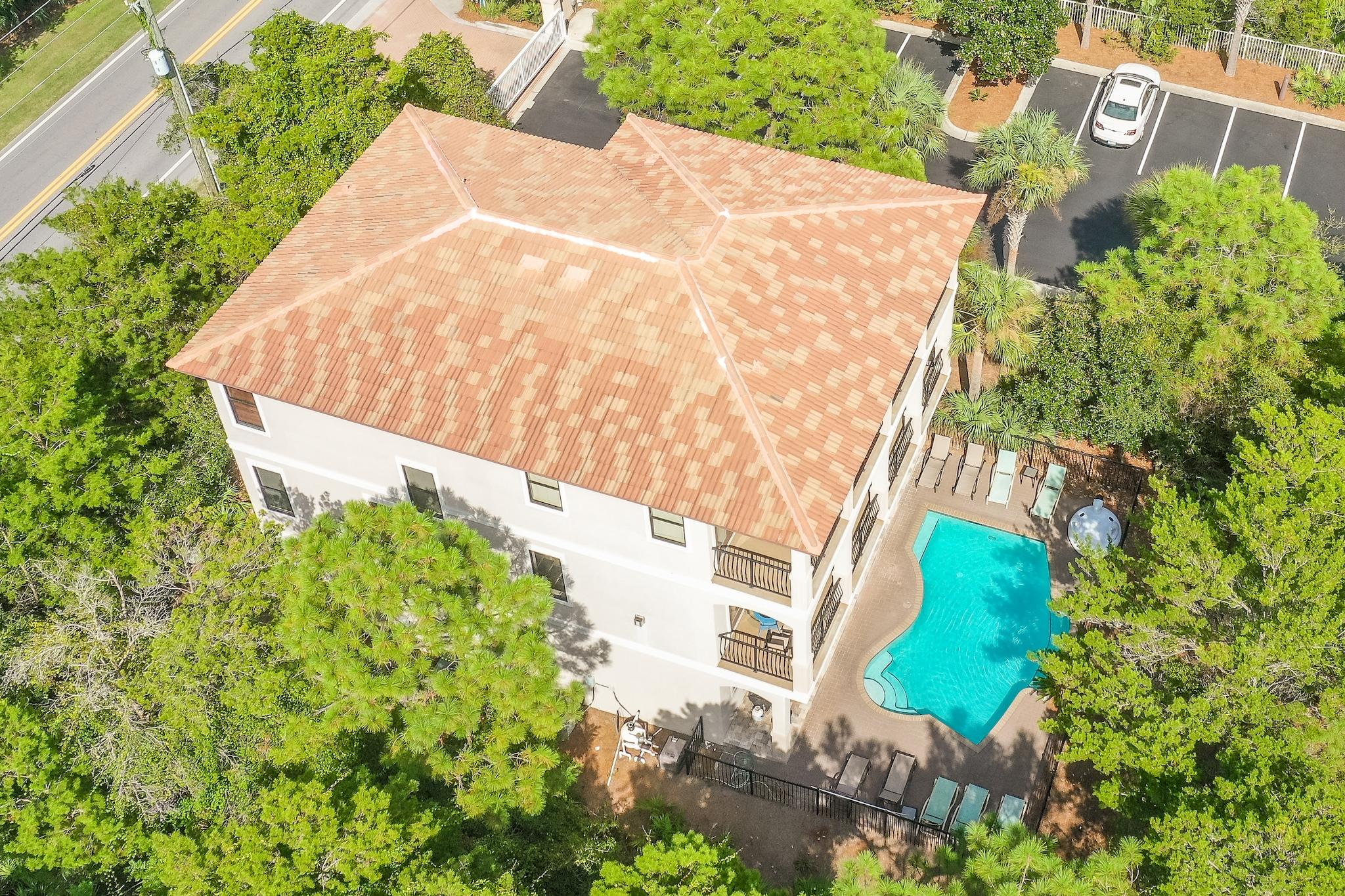 Nestled along 30A, this luxury residence is steps away from the white sand and stunning Emerald Coast water. The open floor plan boasts over 4,200 square feet of thoughtfully designed living area. The newly renovated kitchen features quartz countertops with an oversized breakfast bar and dining area. Enjoy the idyllic lush backdrop of Florida pines through the French doors and ample covered patio space on both the second and third floors. A wet bar and gas fireplace with shiplapped mantle complement the living room. Two master suites and four additional bedrooms complete the sleeping quarters.  Make a splash in the private pool complete with water feature, sunning deck, and private outdoor shower.