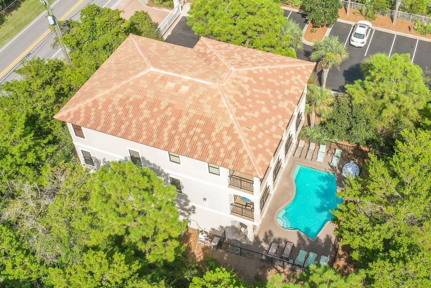 Nestled along 30A, this luxury residence is steps away from the white sand and stunning Emerald Coast water. The open floor plan boasts over 4,200 square feet of thoughtfully designed living area. The newly renovated kitchen features quartz countertops with an oversized breakfast bar and dining area. Enjoy the idyllic lush backdrop of Florida pines through the French doors and ample covered patio space on both the second and third floors. A wet bar and gas fireplace with shiplapped mantle complement the living room. Two master suites and four additional bedrooms complete the sleeping quarters.  Make a splash in the private pool complete with water feature, sunning deck, and private outdoor shower.