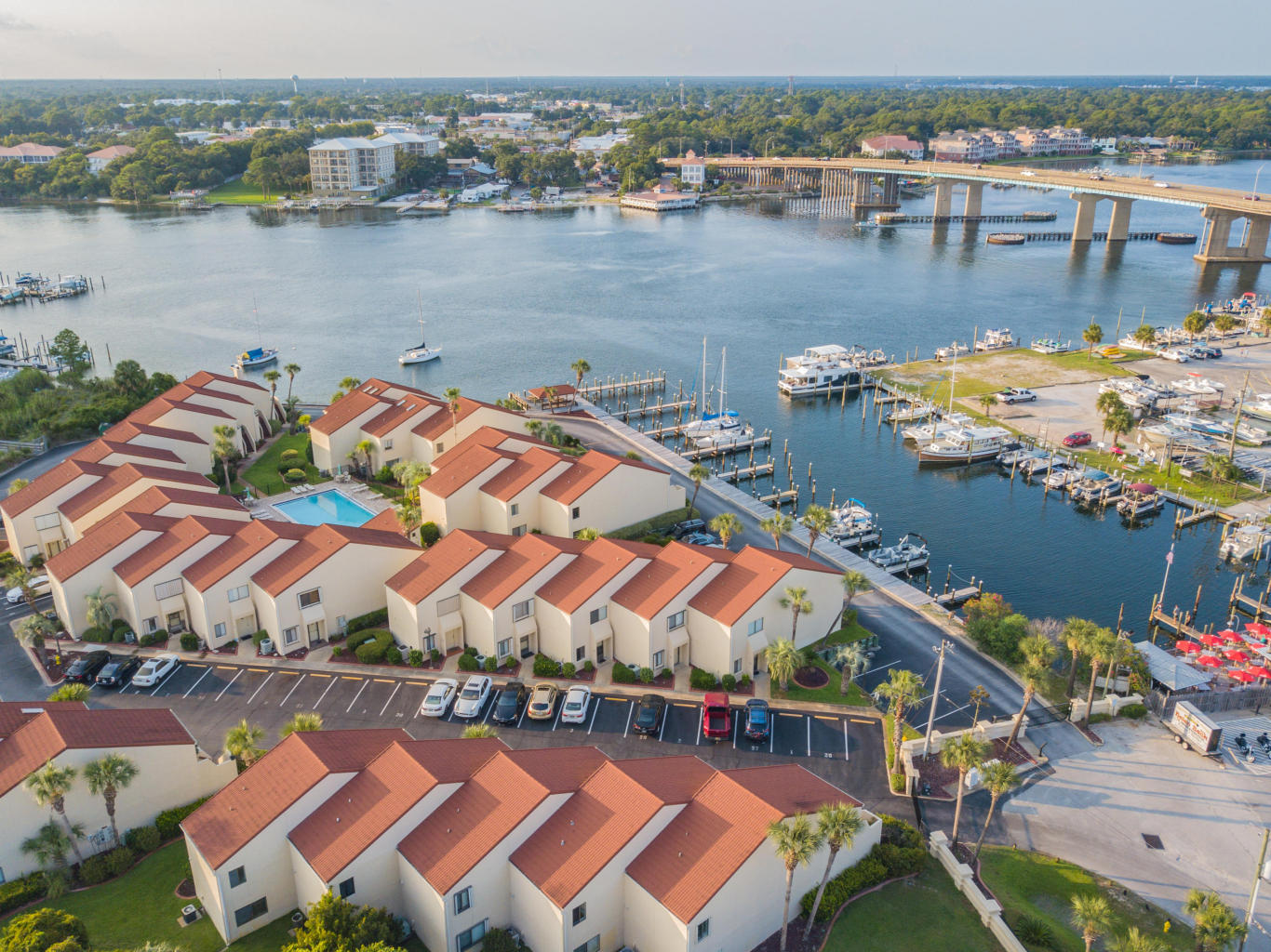 CALLING ALL INVESTORS! Incredible price for a fixer upper in a beautiful and sought after waterfront community!! Selling AS IS. Great location in quiet gated community on Okaloosa Island, a 5 minute walk to the beach. Hot water heater installed 3/2019. Two master suites on the 2nd floor with their own private bathrooms, and one with its own balcony (overlooks the pool!). Complex has a marina w/ boat slips available for rent, covered gazebo area on the water (great for fishing & watching the dolphins play), and also a large swimming pool surrounded by beautiful brick pavers & tropical landscaping. Complex has beach walkover that leads to the Gulf! Roof is Stone-coated steel tile rated to withstand 140mph winds, installed in 2006.