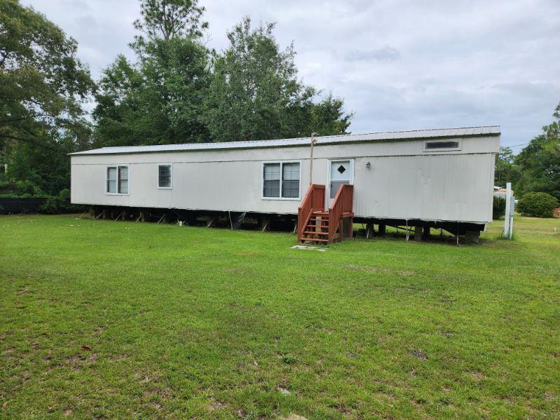 UNDER CONTRACT, SELLERS TAKING BACKUP OFFERS!! Excellent Deal!! This 2 bed 2 bath singlewide mobile home is a must see! It's waiting for you to make it a great little get-a-way for vacation and/or it can be a turned into a sweet short/long-term term rental investment property located within 45 minutes of our beautiful white sandy beaches along the Emerald Coast. Upgraded in 2021 with a new metal roof, new hvac system, new septic tank, new electrical meter and panel and well, sod added and some cosmetic updates were made inside to include paint, flooring, and bathrooms. All completed at that time. Call to schedule your appointment today! Buyers responsible to verify all information of important.