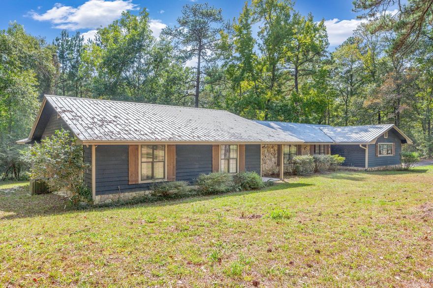 Welcome to your dream retreat! This exquisite 4-bedroom, 3-bathroom oasis is the epitome of laid-back luxury. Nestled on a sprawling 3-acre parcel of land, this home boasts all the comforts and conveniences you could desire.
As you step inside, you'll be greeted by a spacious living space with natural hardwood-looking luxury vinyl plank flooring and elegant tile throughout. The heart of the home, the kitchen, is a chef's dream with granite countertops, an oversized island, and plenty of storage in the walk-in pantry. Cooking and entertaining will be so much fun!
This property features a dedicated office space, allowing you to stay productive while enjoying the serenity of your surroundings.
The master bathroom has a beautiful custom tile shower with a rain shower head and glass doors. Enjoy a long bubble bath at the end of the day in the garden tub and plenty of space at the double vanity.
This home has a second master suite option or endless other options. Whether it's for guests, extended family, or just some extra space to spread out, you'll find the flexibility you need.
Beyond the comforts of the interior, step outside and be captivated by the natural beauty surrounding you. A white sandy bottom creek runs through the back side of the property, offering a tranquil spot to relax and unwind. The expansive 2-car garage provides plenty of storage for your vehicles and more.
For those who like to tinker, create, or just have space to pursue hobbies, the large workshop with a concrete foundation and power is a perfect place to bring your projects to life.
Other noteworthy features include wood siding with some beautiful stone work as well on the exterior for that classic charm, double-pane windows for energy efficiency, and a seamless blend of style and functionality throughout.
If you're seeking a place where tranquility meets practicality, this 4-bedroom, 3-bathroom haven with an office, walk-in pantry, 2-car garage, and 3 acres of land is the answer to your dreams. 
Convenience meets comfort in this lovely home, perfectly situated just 1.5 miles from Walmart and near all the amenities of town. This location offers the best of both worlds - the ease of accessing everyday essentials while still enjoying the tranquility of your own space. It's the ideal blend of comfort and convenience. Don't miss out on the opportunity to make this well-located house your new home!