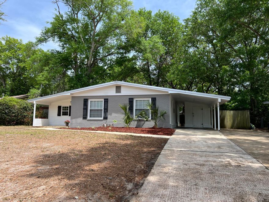 Don't let the age of this home fool you! The effective age per the property appraiser is 2009! The home has been rewired, new windows, kitchen and bath renovations along with a new metal roof in 2016. Bright white kitchen with granite counters and stainless steel appliances. Kitchen could be expanded by adding an island or a peninsula under the windows. The large nearly 1/4 acre homesite is anointed with beautiful mature trees. There is a covered carport with a storage room along with an extra parking pad for boat or extra cars. You are a just a short distance to the Mary Esther city pier and boat ramp on the Sound. This rare 4 bedroom 2 full bath home offers large bedrooms and a bonus room.  Great location within minutes to Eglin AFB or Hurlburt Field!