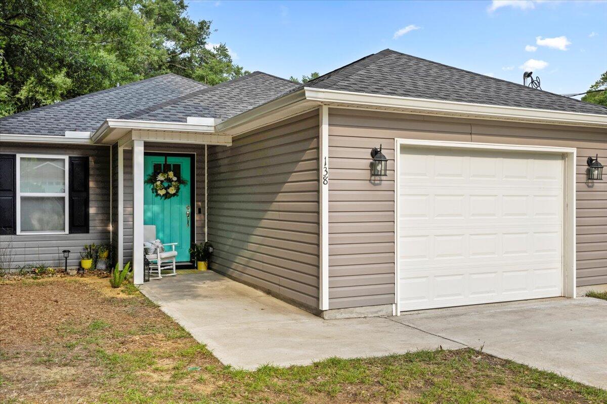 Welcome to this beautifully designed 3BR/2BA home nestled in a convenient, walkable location around dining, shopping, and major employers. Step inside to an open-concept layout with luxury vinyl plank flooring and soaring 9' ceilings that create a light, airy feel. The kitchen is a showstopper with granite countertops, solid wood cabinets, a spacious island, and large pantry--ideal for hosting. The serene primary suite features generous closets and marble-topped vanities. Enjoy peaceful mornings on the covered back porch and the ease of an oversized one-car garage.