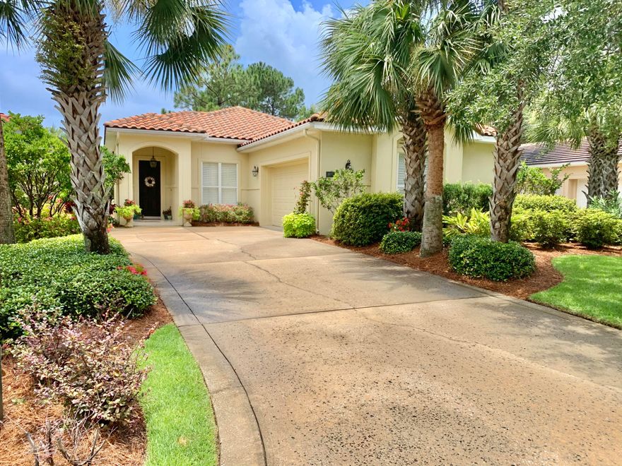 This beautiful stucco home is located in a small quiet neighborhood in Sandestin with lake views.  It has high ceilings with crown molding and travertine flooring throughout       There is a great screened porch and patio area looking out on the lake.  You will love  sitting here.   The kitchen has lots of cabinets and granite counter tops.  There is a 2 car garage  and a separate laundry with more storage and cabinets.   The master bedroom has a walk in closet and a big bath with double sink, a tub and  a separate shower.  There are two guest bedrooms  in this split bedroom plan and one has a wall of built ins and a small desk office area.  The landscaping around the house is lush and loaded with flowers and tropical plants.  A tile roof competes this Florida style home.