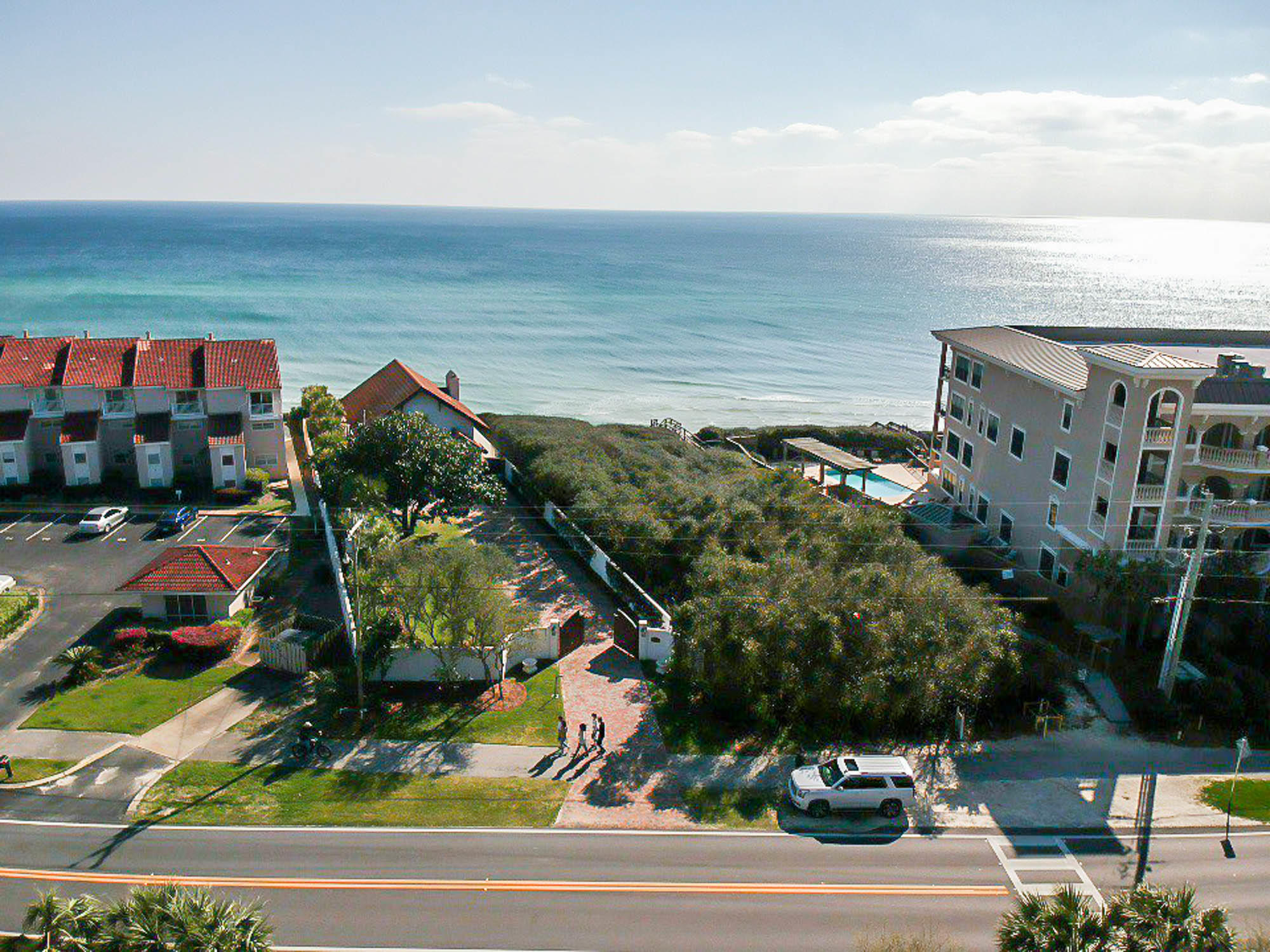 Expansive gulf-front home-site, sitting approximately 38 feet atop sea level, encompassing .60 acres and 64.43 feet of gulf frontage. Astonishing views of the sugar white sands and emerald waters of the Gulf of Mexico will be enjoyed by the future homeowner. But it does not end there - it is only befitting for an estate such as this to have a dwelling of equivalent immensity. Meticulously crafted and customized architectural plans for a beachfront manor will convey with the sale. These plans feature 7,320 s.f. heated and cooled, 2,739 s.f. covered porches, 1,371 s.f. of garage space, 10 bedrooms, 12 full bathrooms and 1 half bathroom.Pay attention to the lot placement, adjoining parcels and the architectural design; you will realize nearly 180-degree views from this magnificent